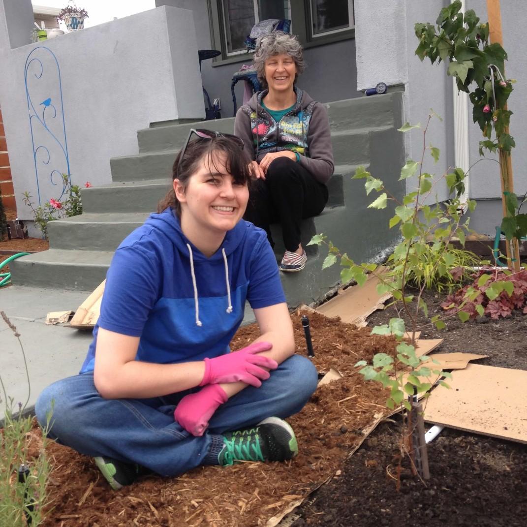 Cara planting the birch saplings from her mom's garden in ours.