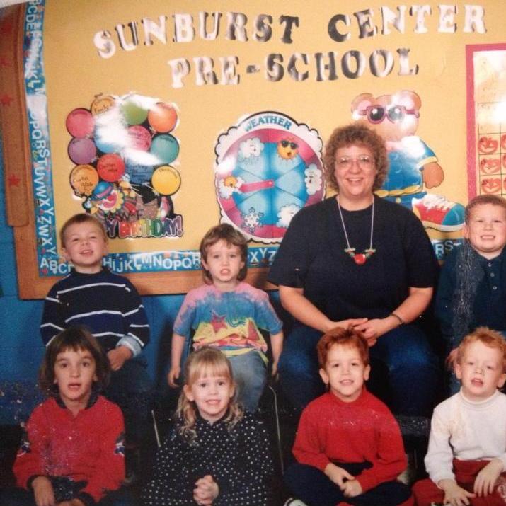 We first met when we attended the same pre-school! We are sitting next to each other in the front row.