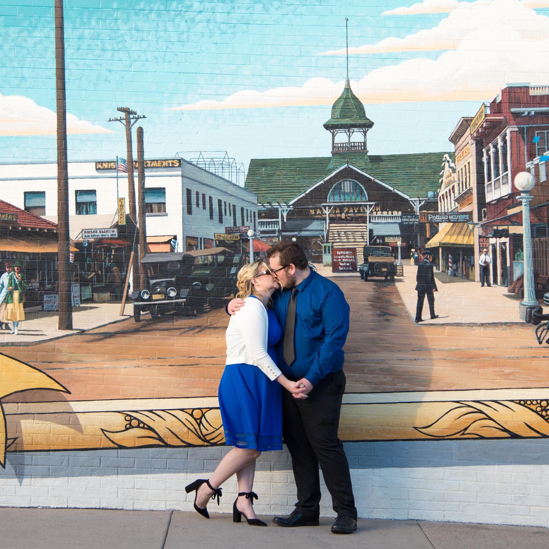 Kissing in front of the mural