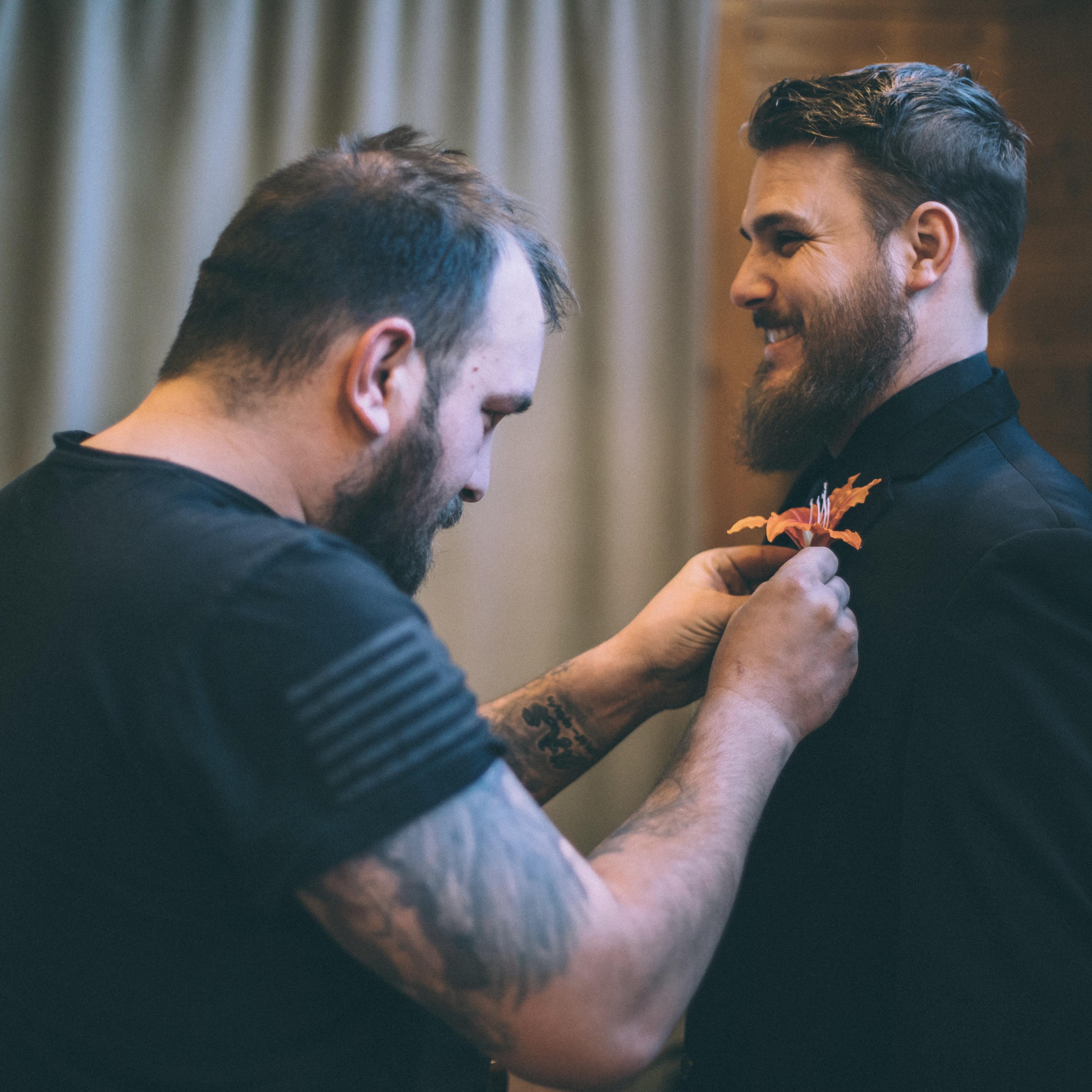Brandon attaching Tylers boutonniere