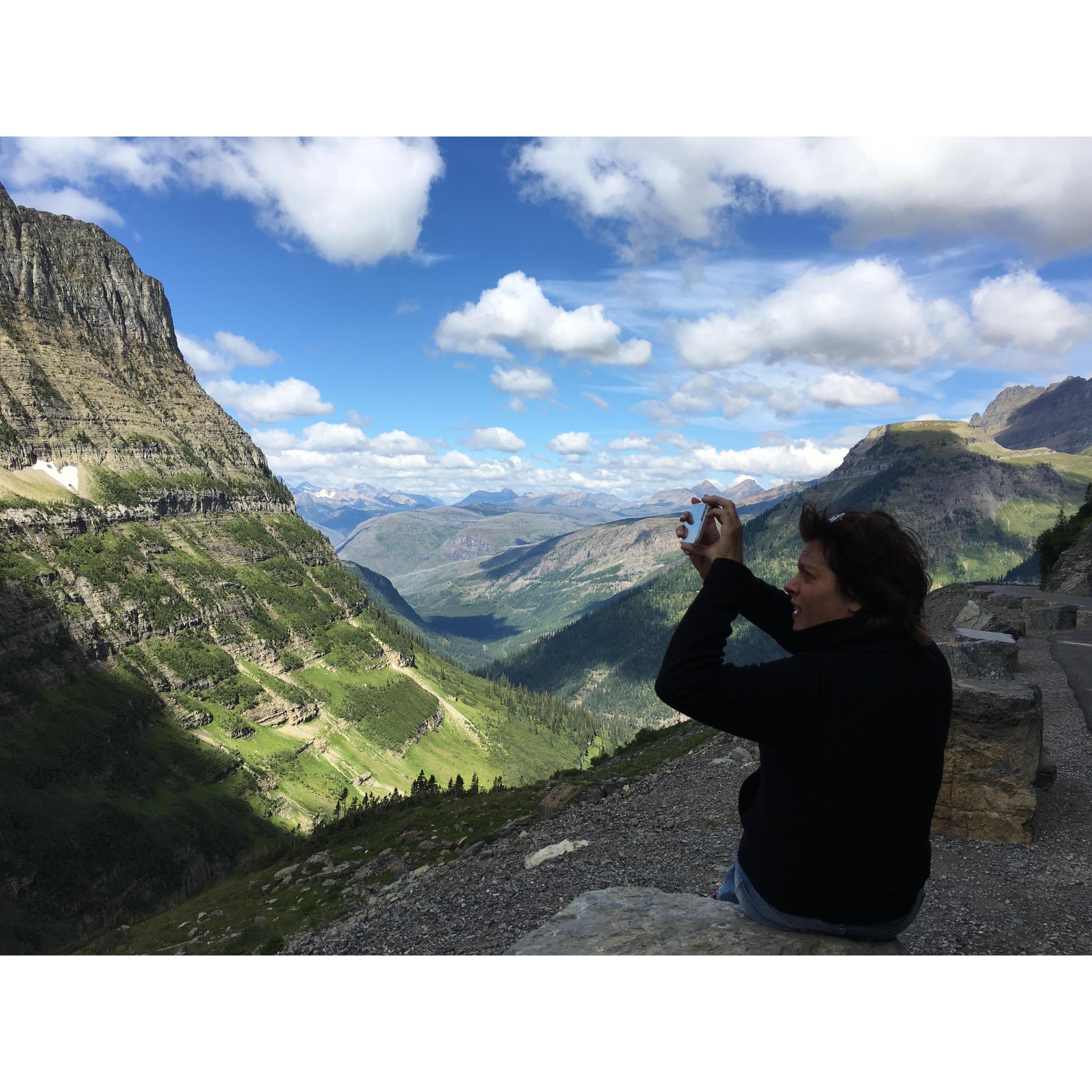 Robert capturing Lisa capturing a shot on the Going-to-the-Sun Road in Glacier.