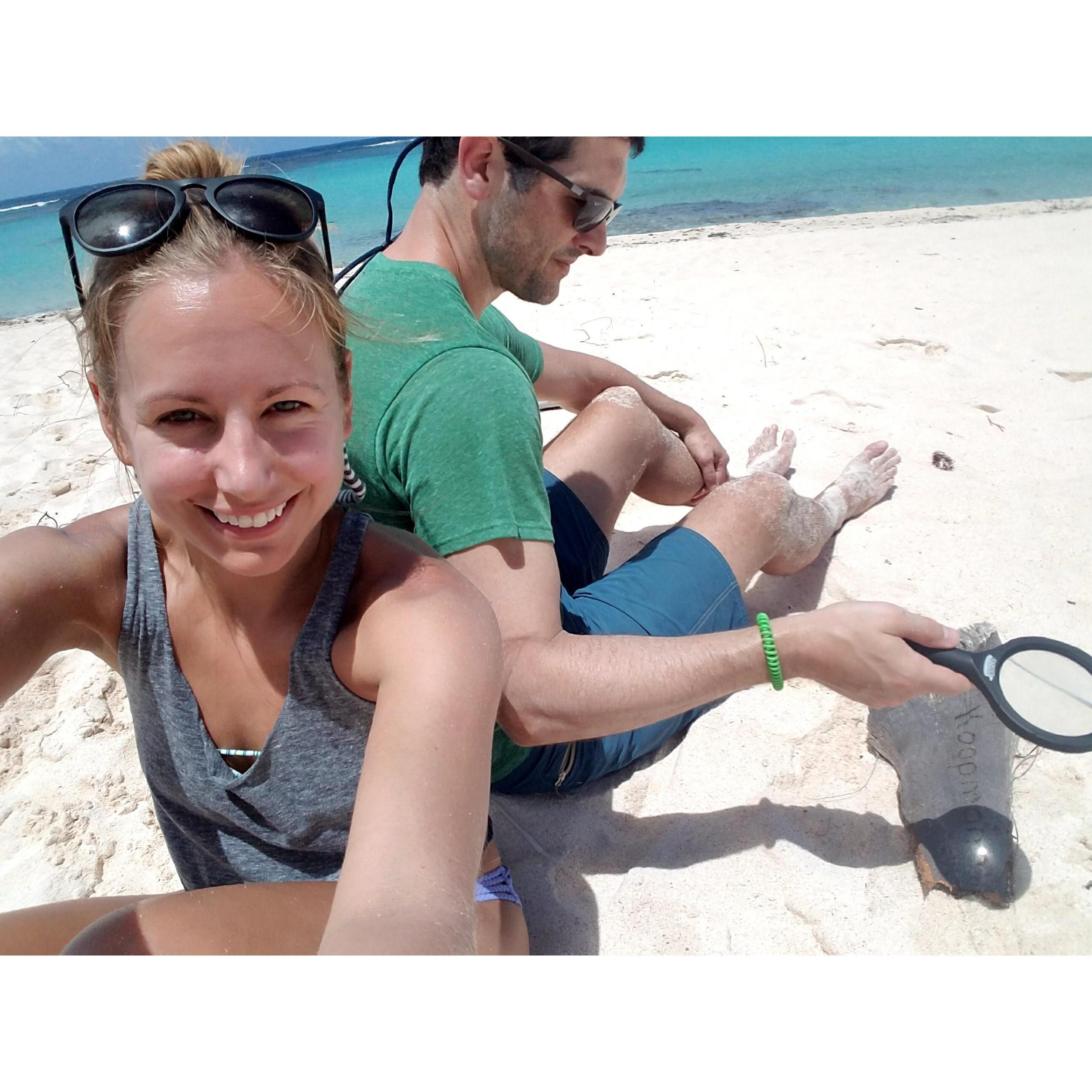 Steven working hard to write a message on a piece of driftwood. Virgin Islands, May 2017.