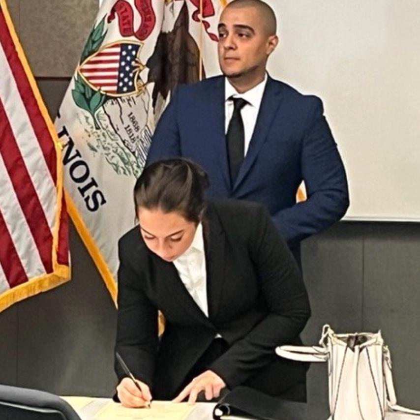 Signing our contracts with Aurora PD together during our swearing in ceremony in 2022