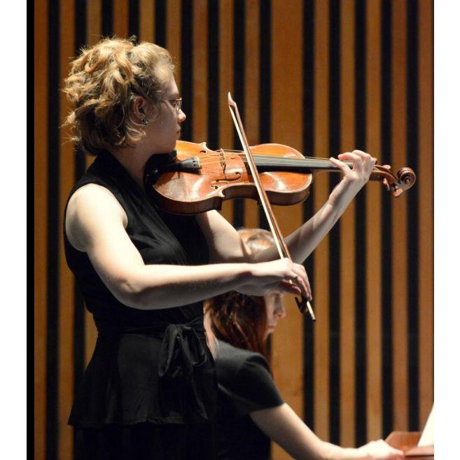 Katie playing violin at her graduation recital for her MM degree.