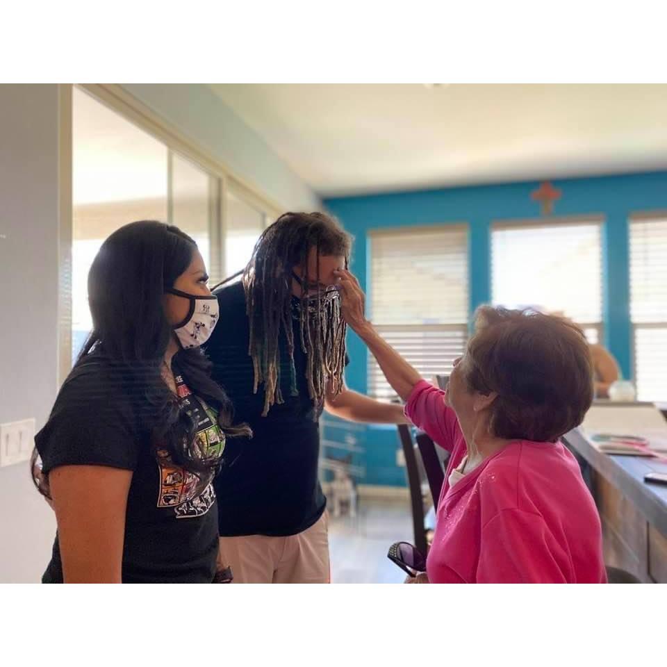 Grandma Dolores giving Brandon a blessing during wedding prep