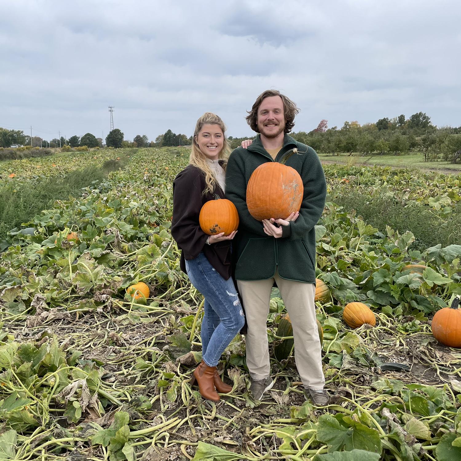 Two gourds holding pumpkins