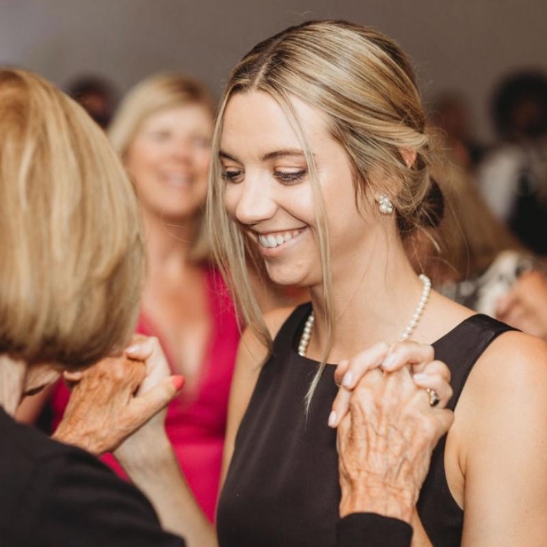 Mike made his move by cutting in while Nikki was dancing with her grandmother. With a charming smile, he asked, 'Mind if I steal a dance with her?' and twirled Nikki's grandma onto the dance floor.
