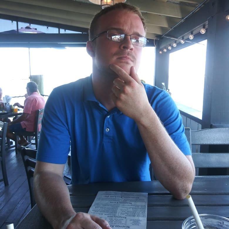 Such a handsome man, pondering what to order off of the menu at Dixie Fish Co