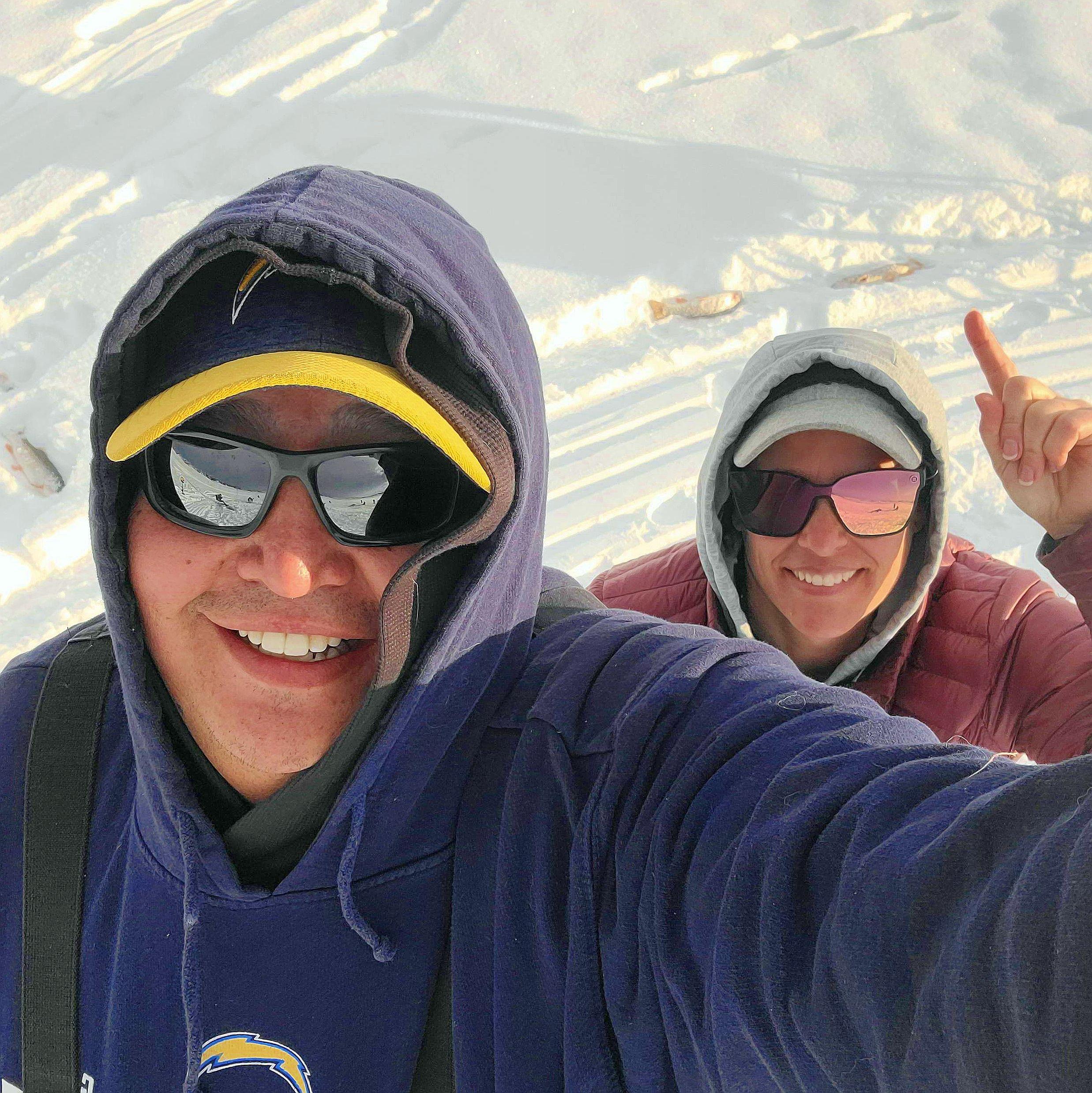 One of our first ice fishing trips. Technically, I'm pointing at the fish we caught, not giving the "we're #1 sign"! Haha!