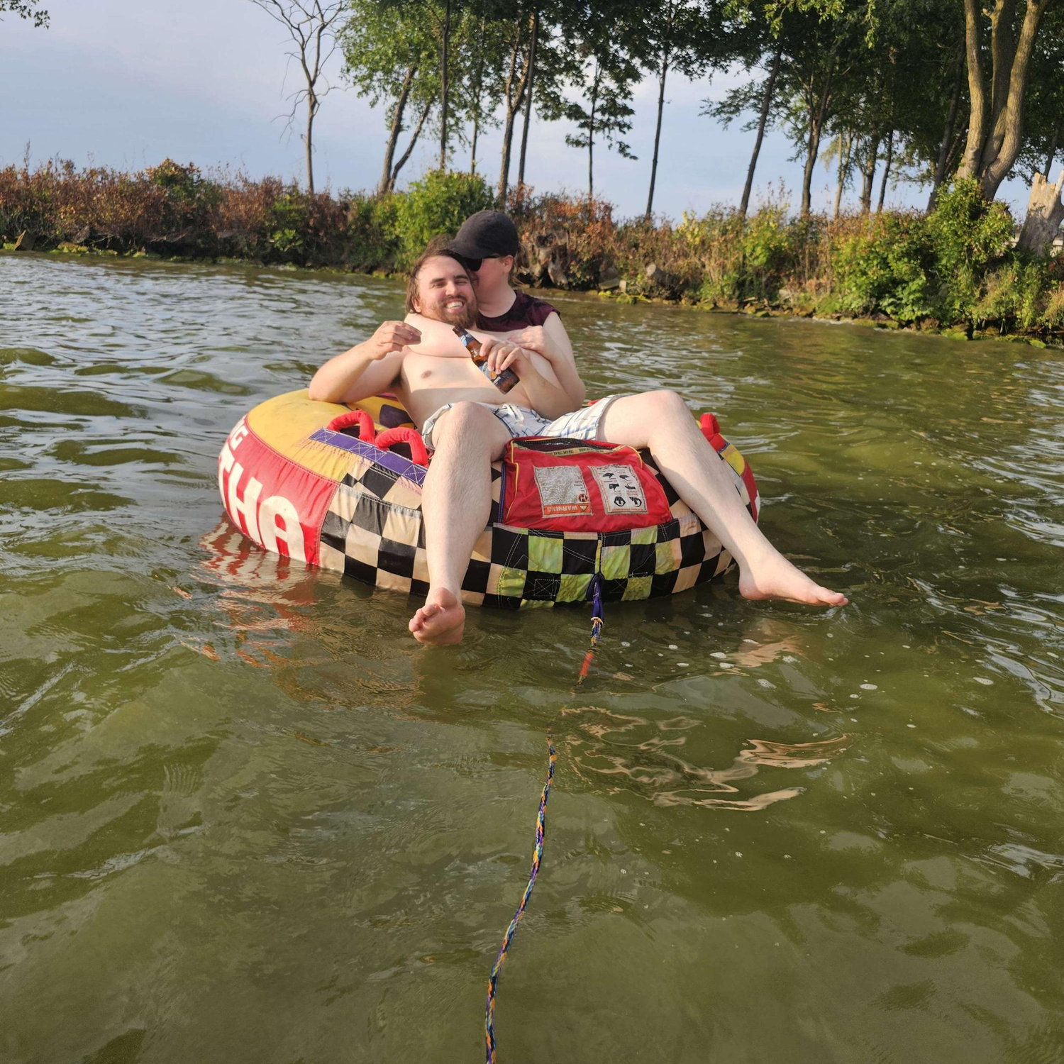Tubing on the lake! Alex and Arliss cuddle and sip drinks afterwards.