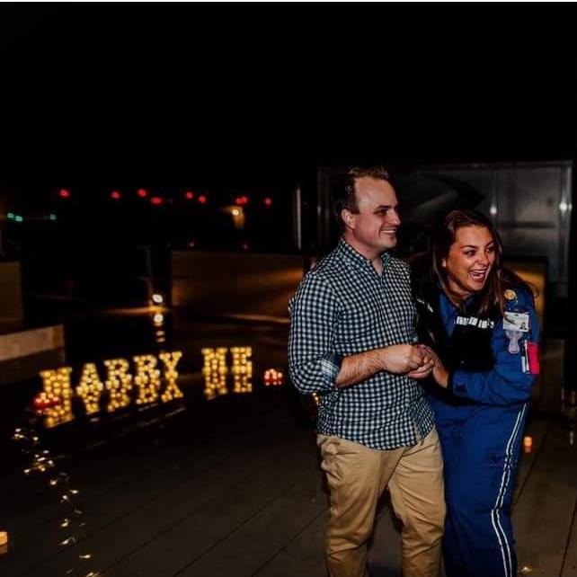 Chase snuck up onto the roof of Duke Hospital right before Kathleen was about to do her nightly helicopter checks. Chase had decorated the roof and was waiting for her with a very important question!