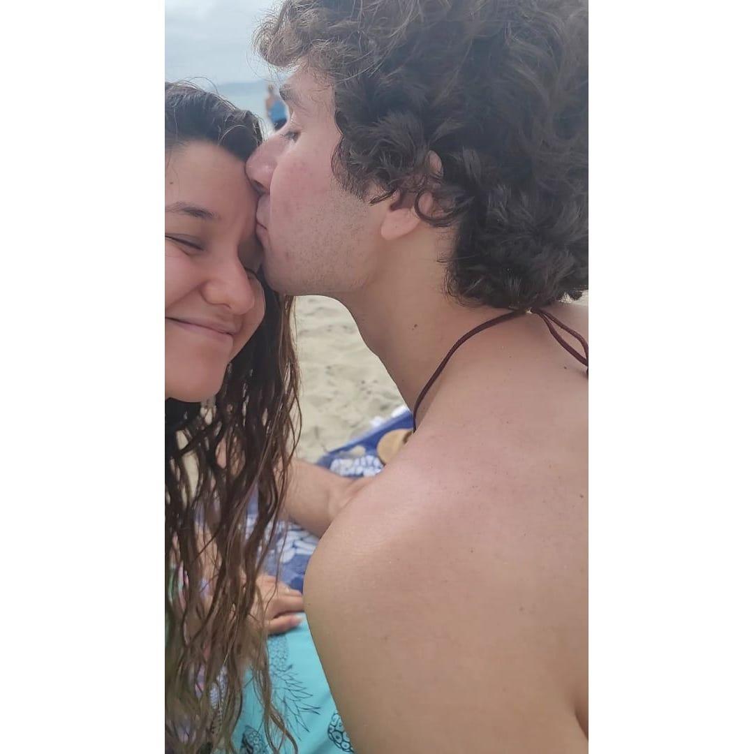 This is a still from a video Genesis took while her and Michael frolicked at a Coronado beach. Here, he is consoling Genesis after she lost her favorite red sunglasses to the ocean. He is pure love.
