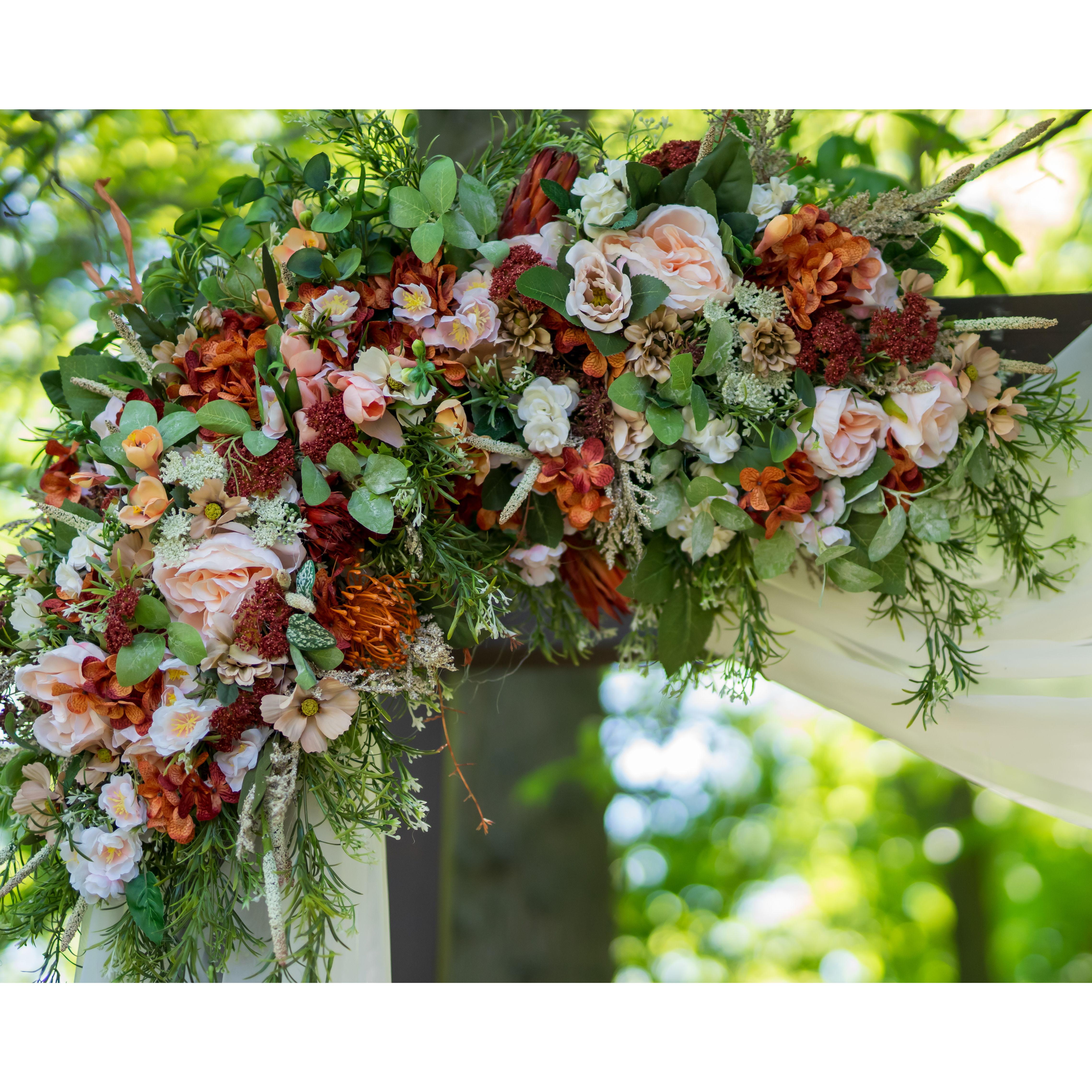 floral decor on our ceremony arch thanks to Jane Nieman!