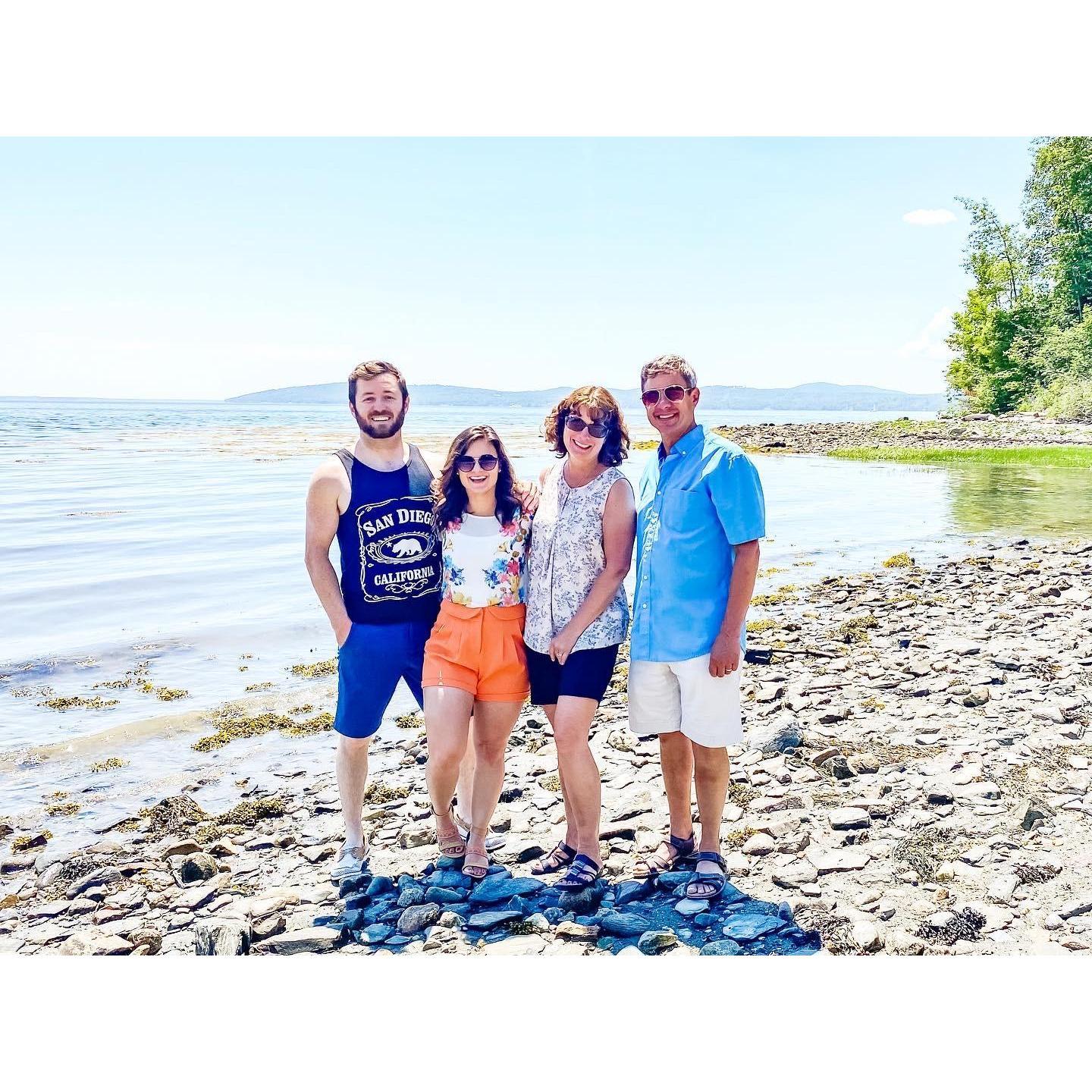 On the beach at their wedding venue with Marissa's parents last summer.