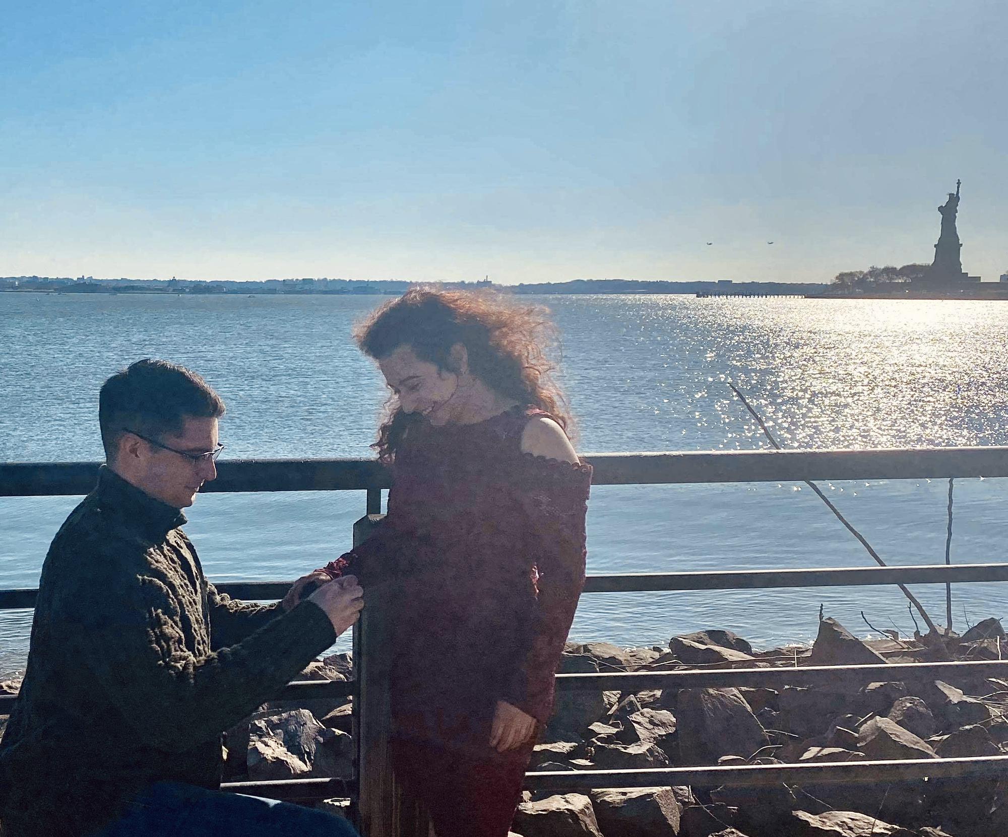 A random stranger took pictures as Sean nervously proposed to Rana in Liberty State Park