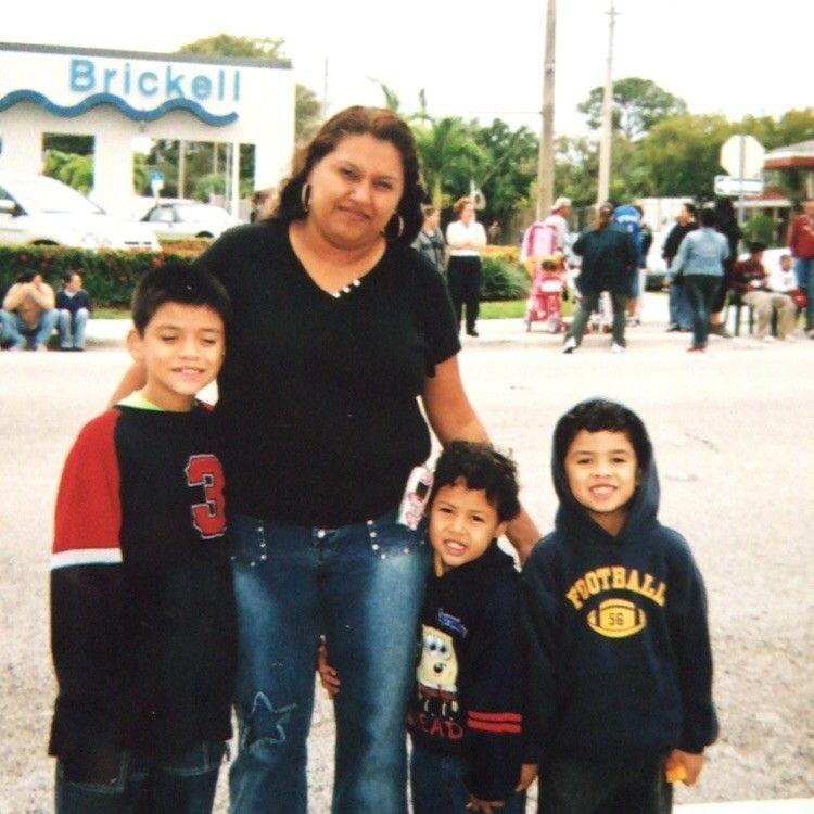 Kenny and his family in downtown watching a parade. (From left to right: Kenny, Ericka, Johnny and Antonio).Downtown Brickell, Florida. 2004