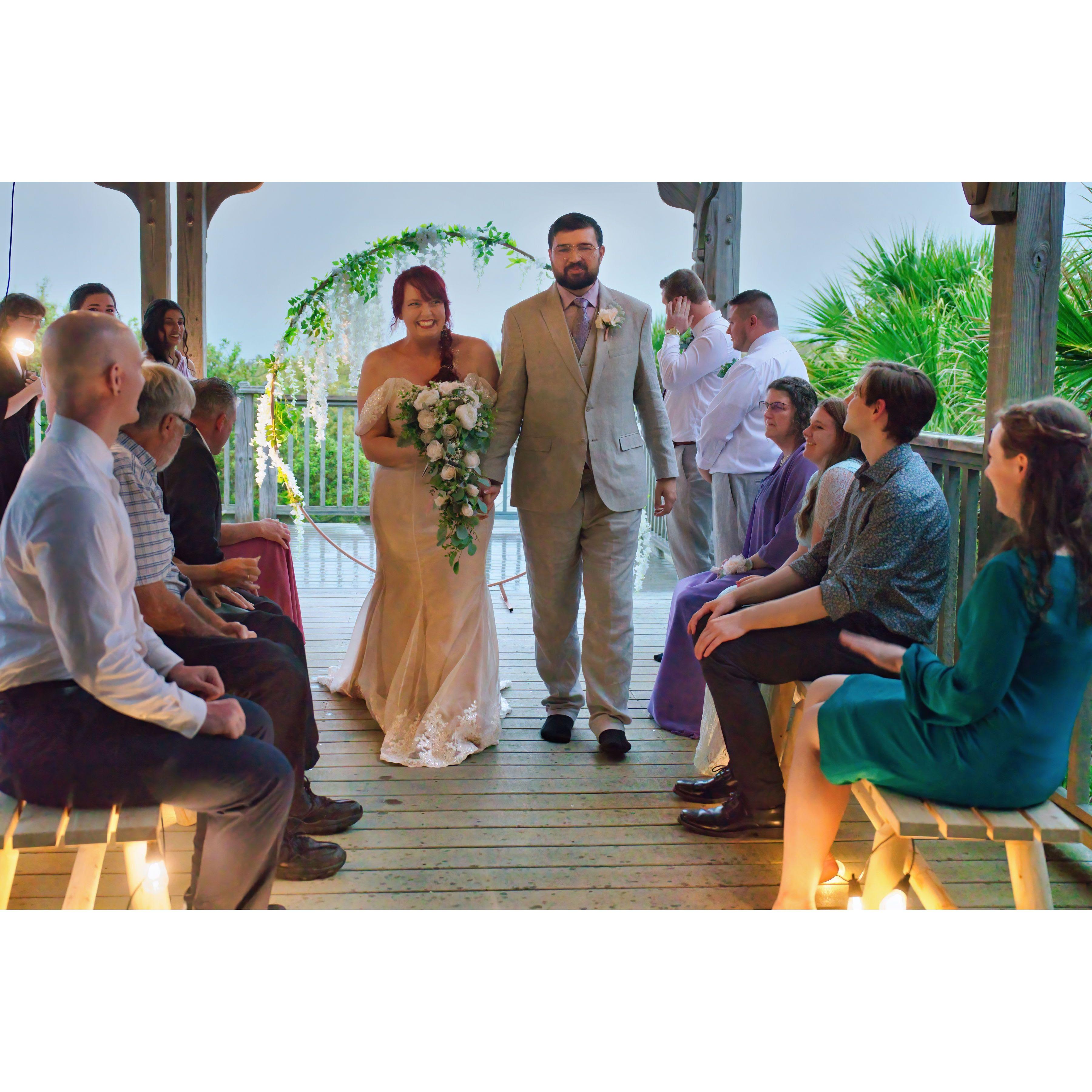 The couple was married on the deck of the rental as the beach had four inches of rain during the couple hours the ceremony took place - the newly weds needed the luck that came with!