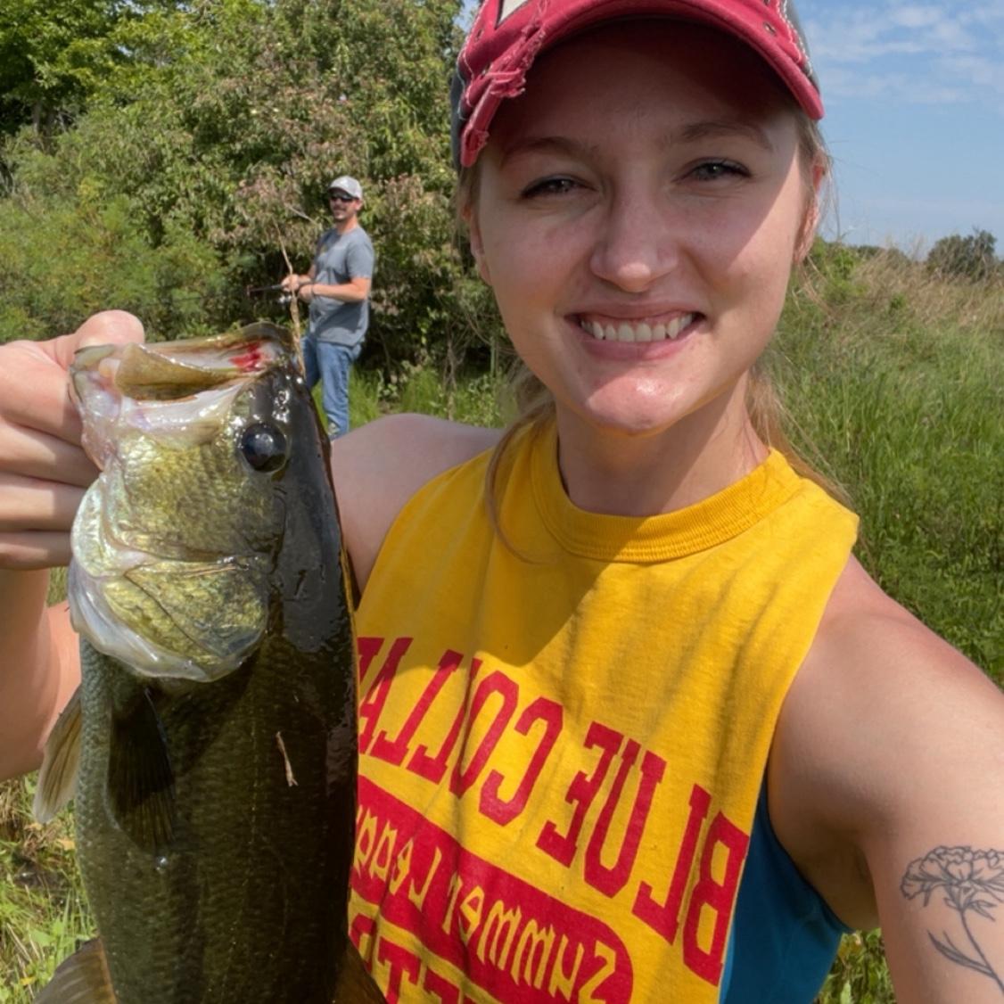 Courtney out-fishing Tanner in pasture ponds located on her Sleezer grandparents' land.