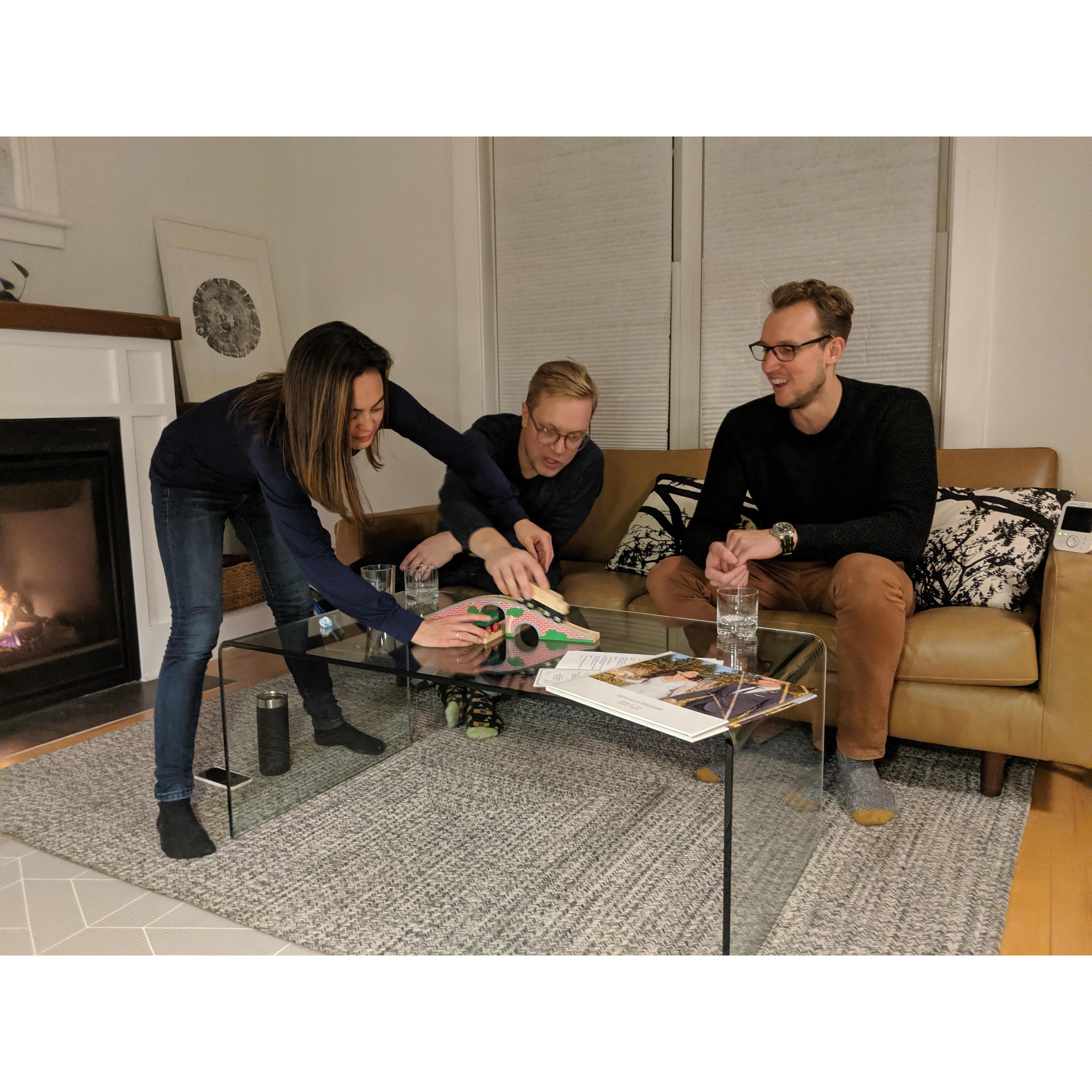 Jane, Mike, and Andrew playing with Adrain's train set, 2019