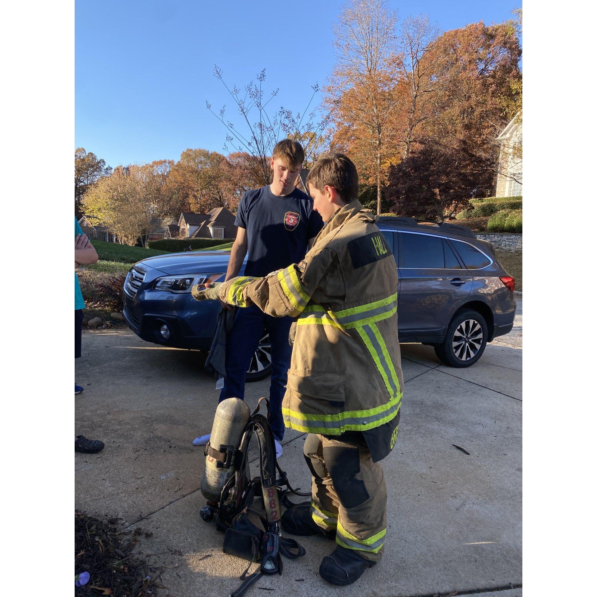 Robbie showing my cousins how to get it done in fire gear!