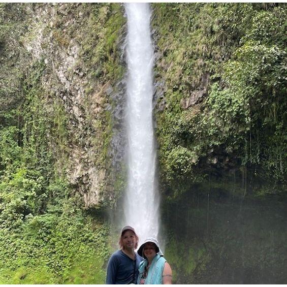 Posing in front of La Fortuna Waterfall in Arenal Volcano National Park in Costa Rica