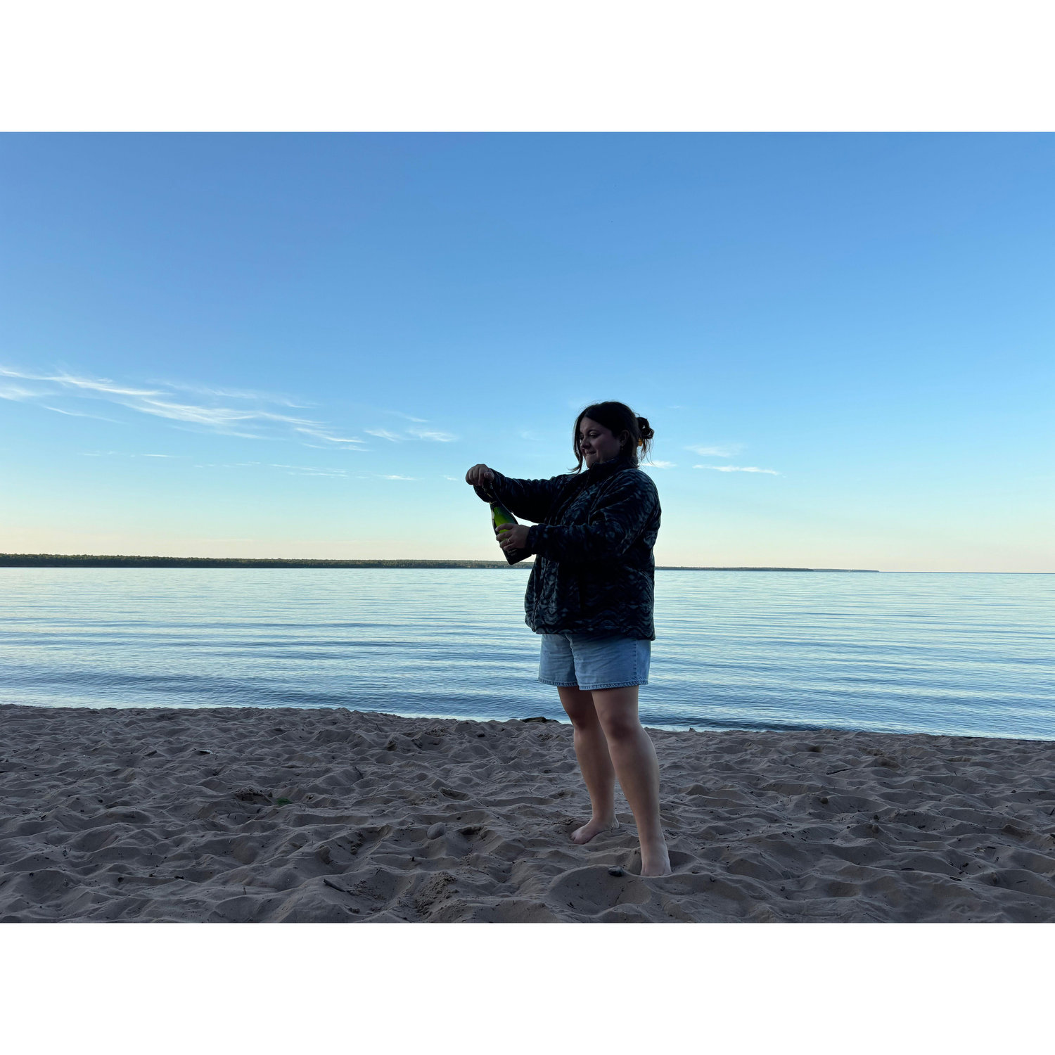 Brianna pops champagne on our private beach after Alissa's proposal at the Apostle Islands (Brianna also said yes)