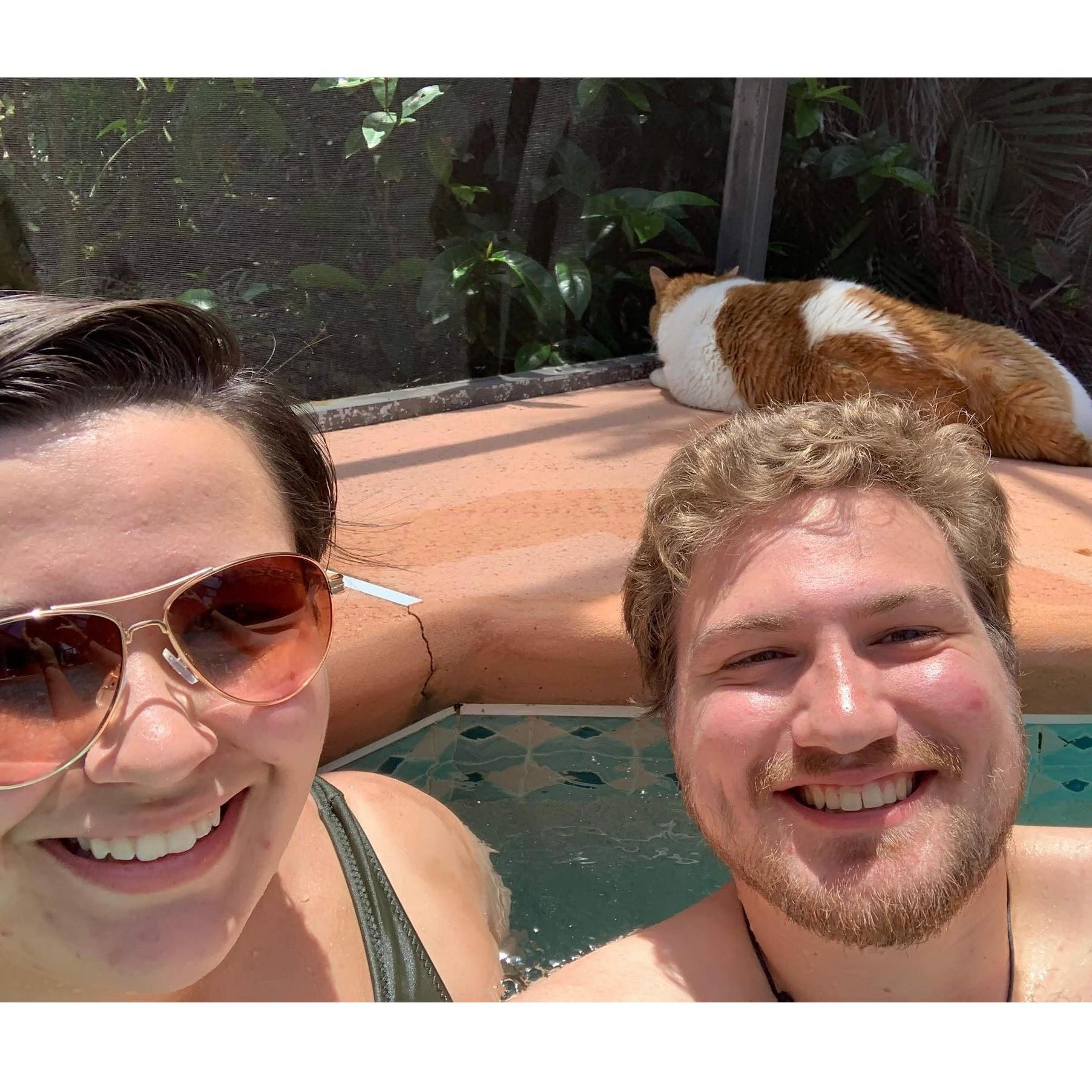 In the pool at Alex's parent's new house, along with their cat Buddy