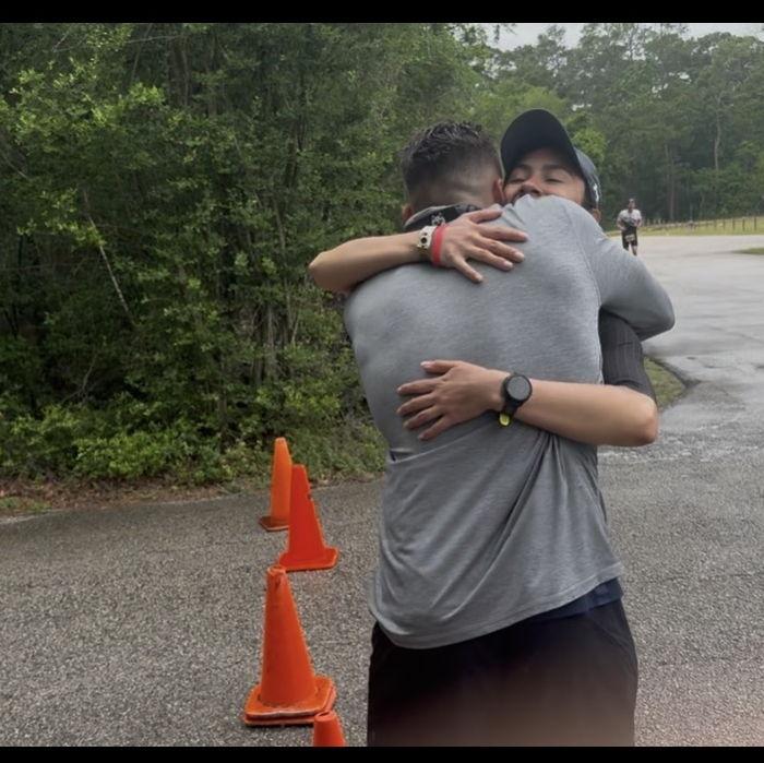 Ethan giving Estela a hugging during her Ironman marathon