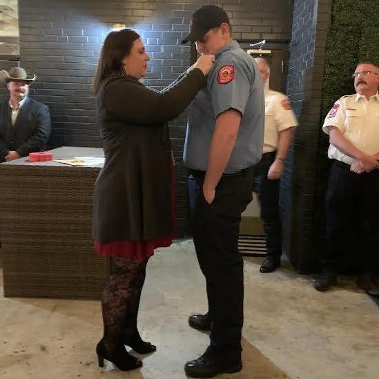 Pinning Steven's badge at the Fire Department Christmas party December 7, 2019.