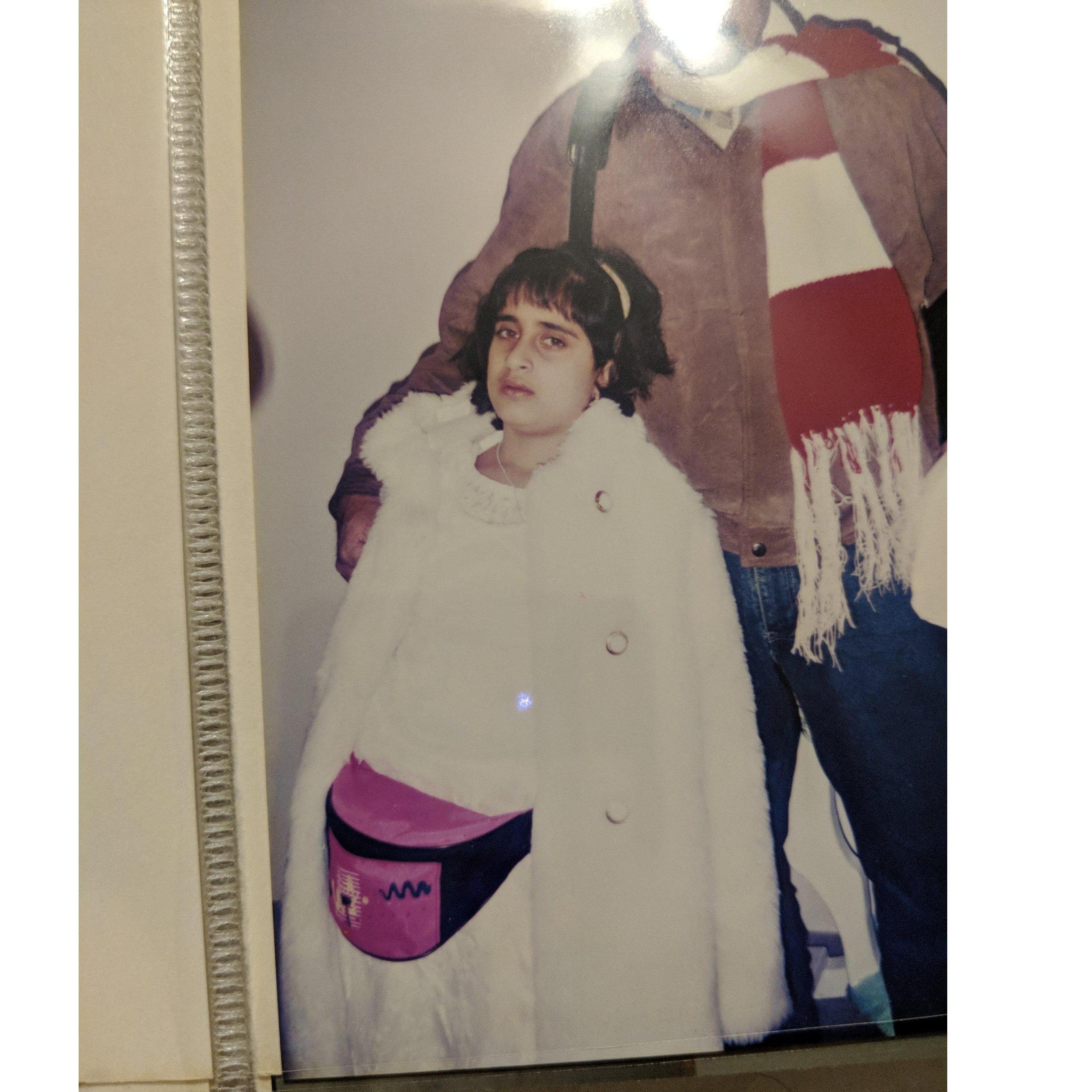 Sporting a fanny pack, faux fur coat, and attitude.