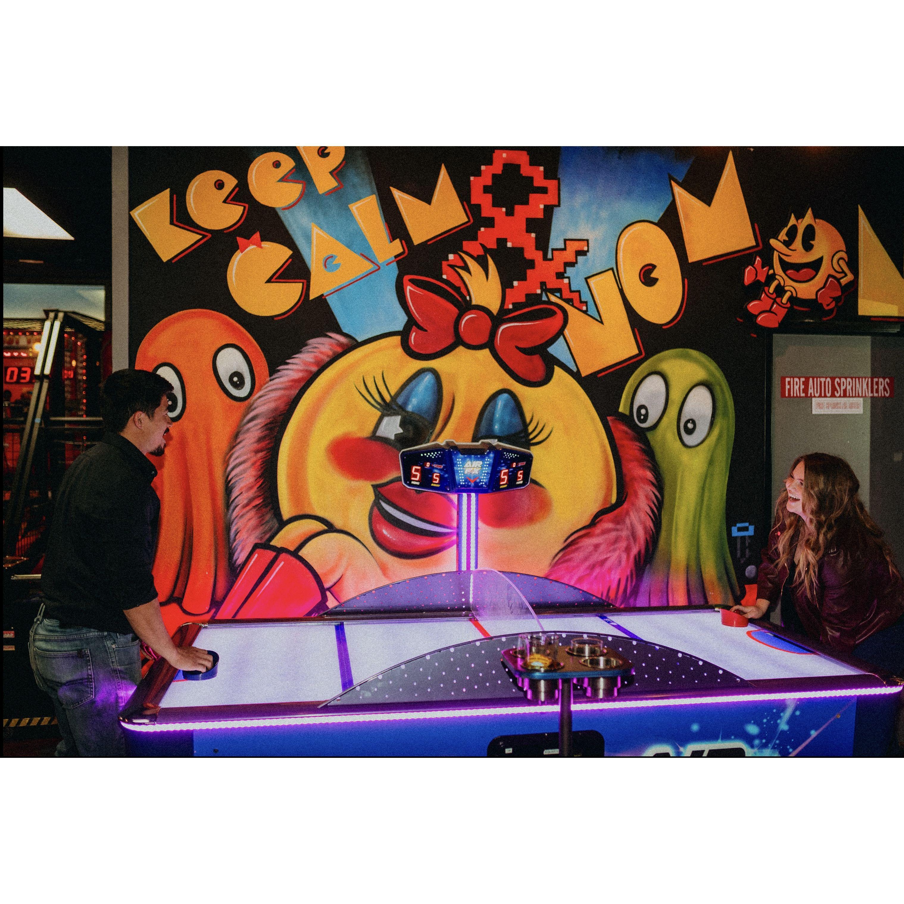 Our first game during our engagement photoshoot. We'll be playing our first game of air hockey as a married couple at the reception!