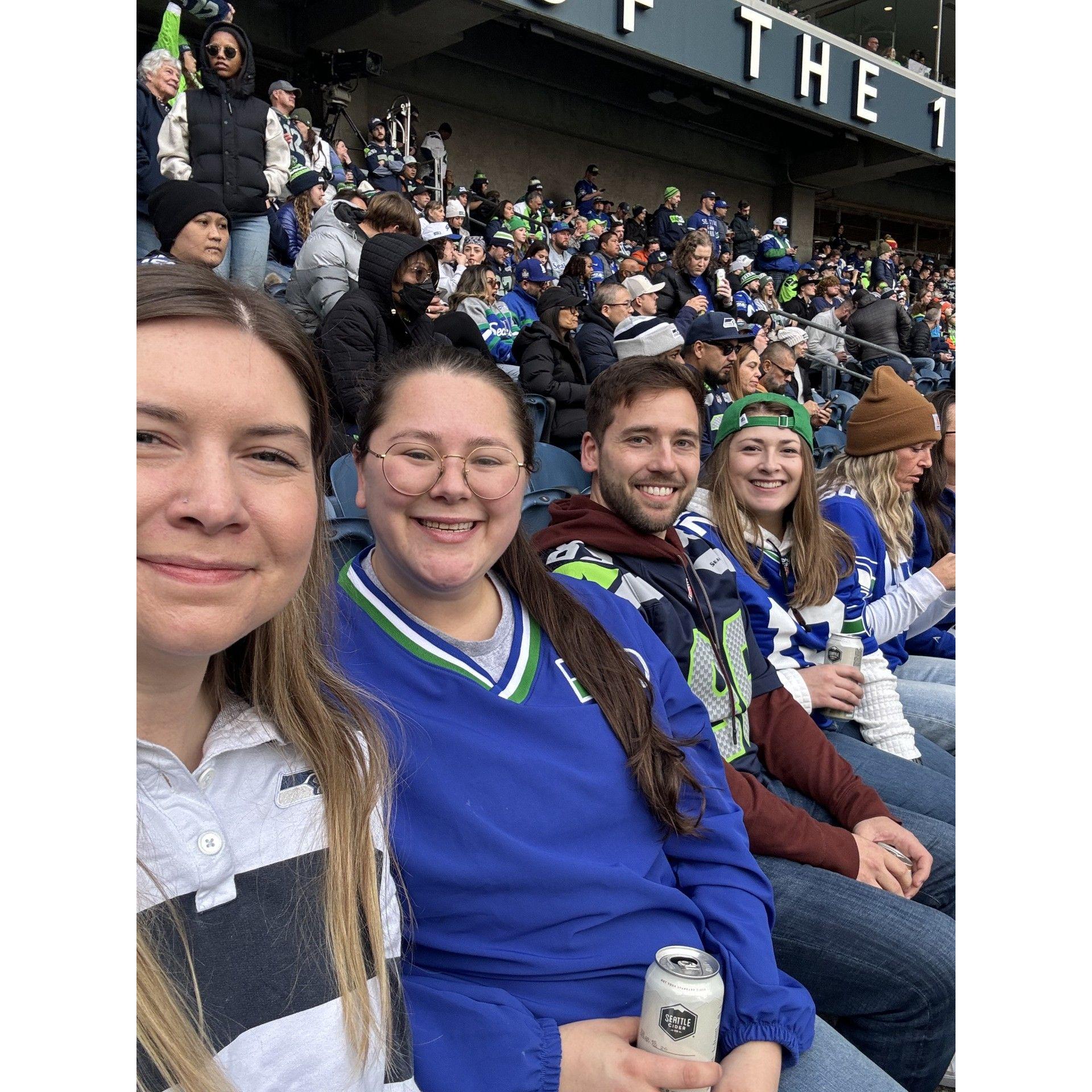 Emma, Emma, Will, and Sam at a Seahawks game! - Geno threw two red zone pics...