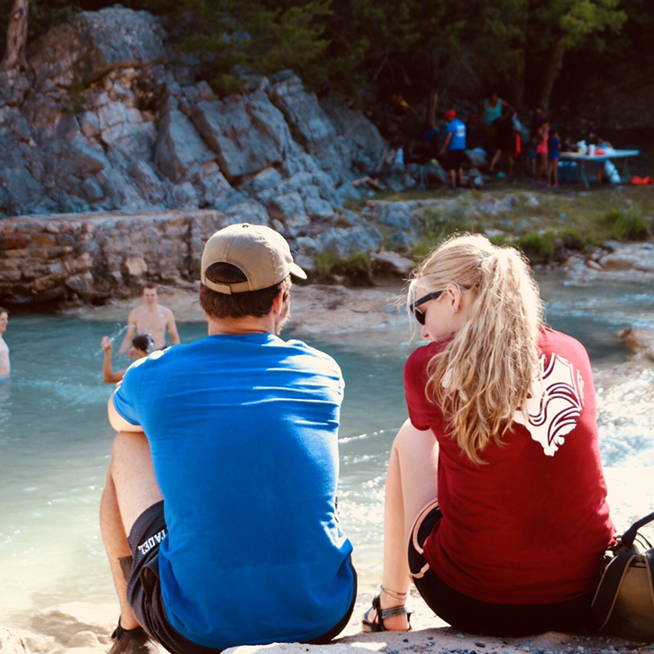 Hanging out talking on a camping trip with friends.