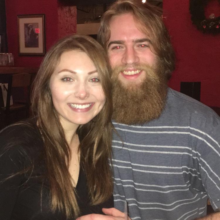 A young couple dines in a rather red restaurant