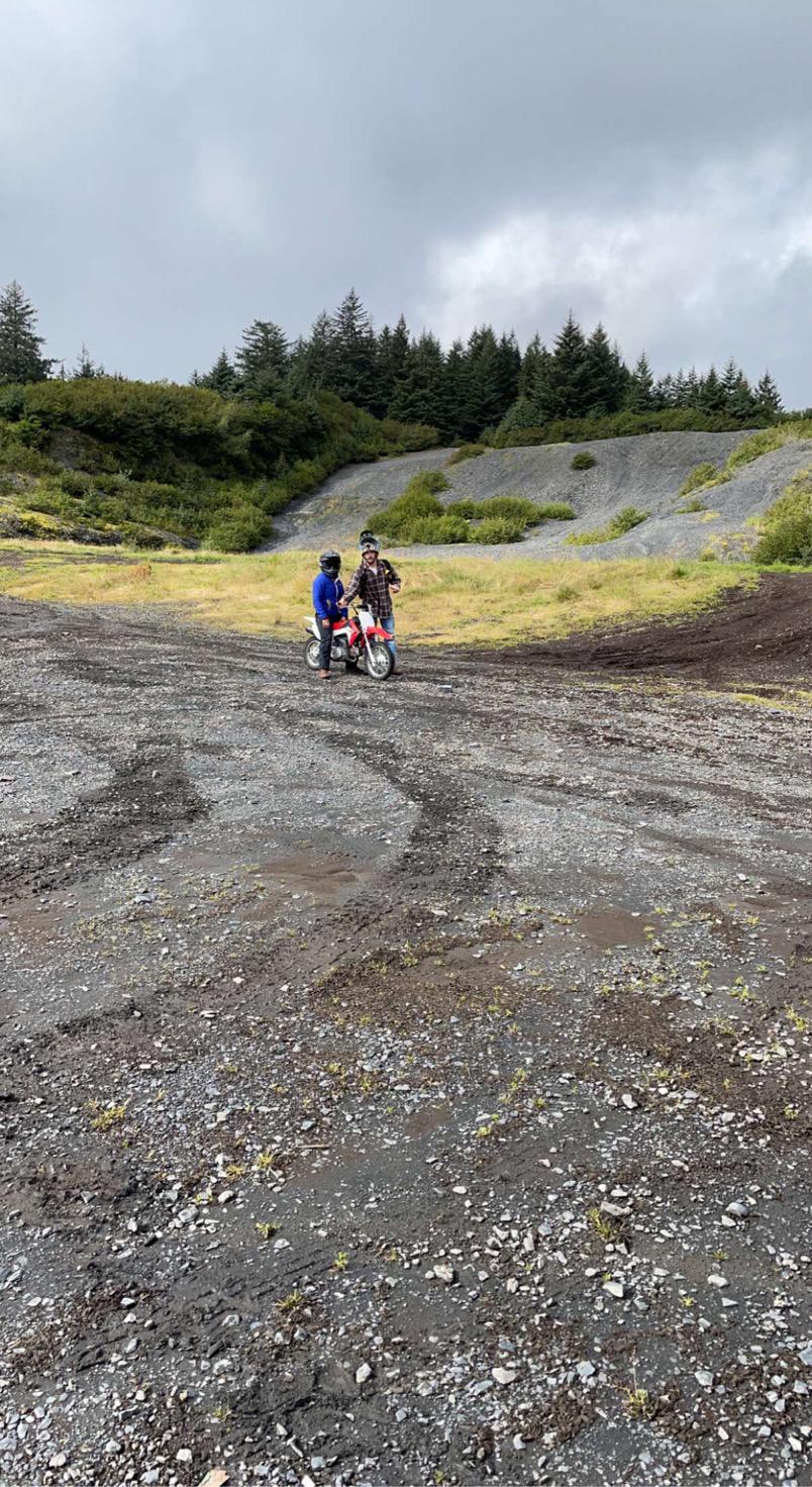 Kaleb’s probably trying to either get on Jamie’s bike or helping her on doing a wheelie