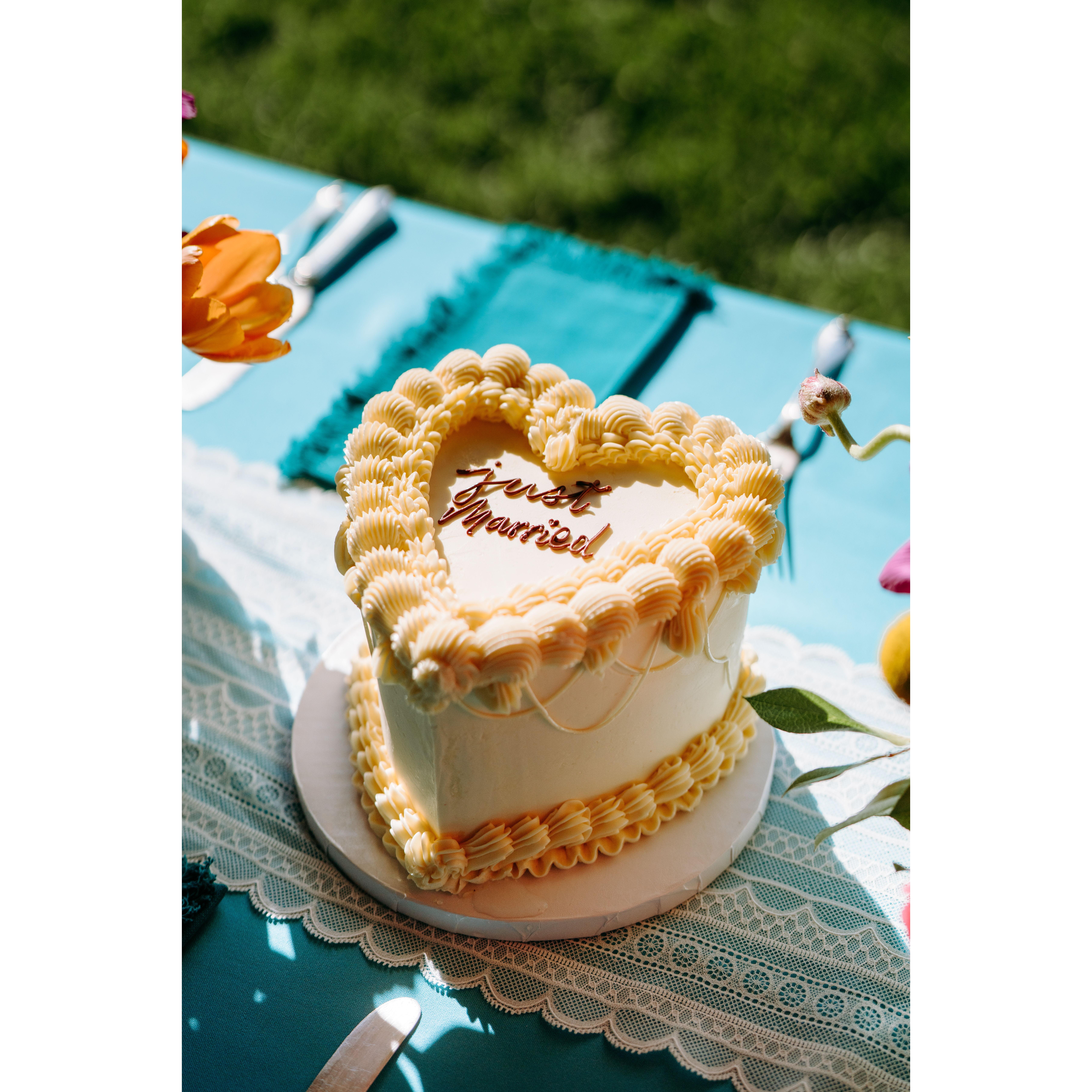 A traditionally piped, white buttercream, heart-shaped wedding cake