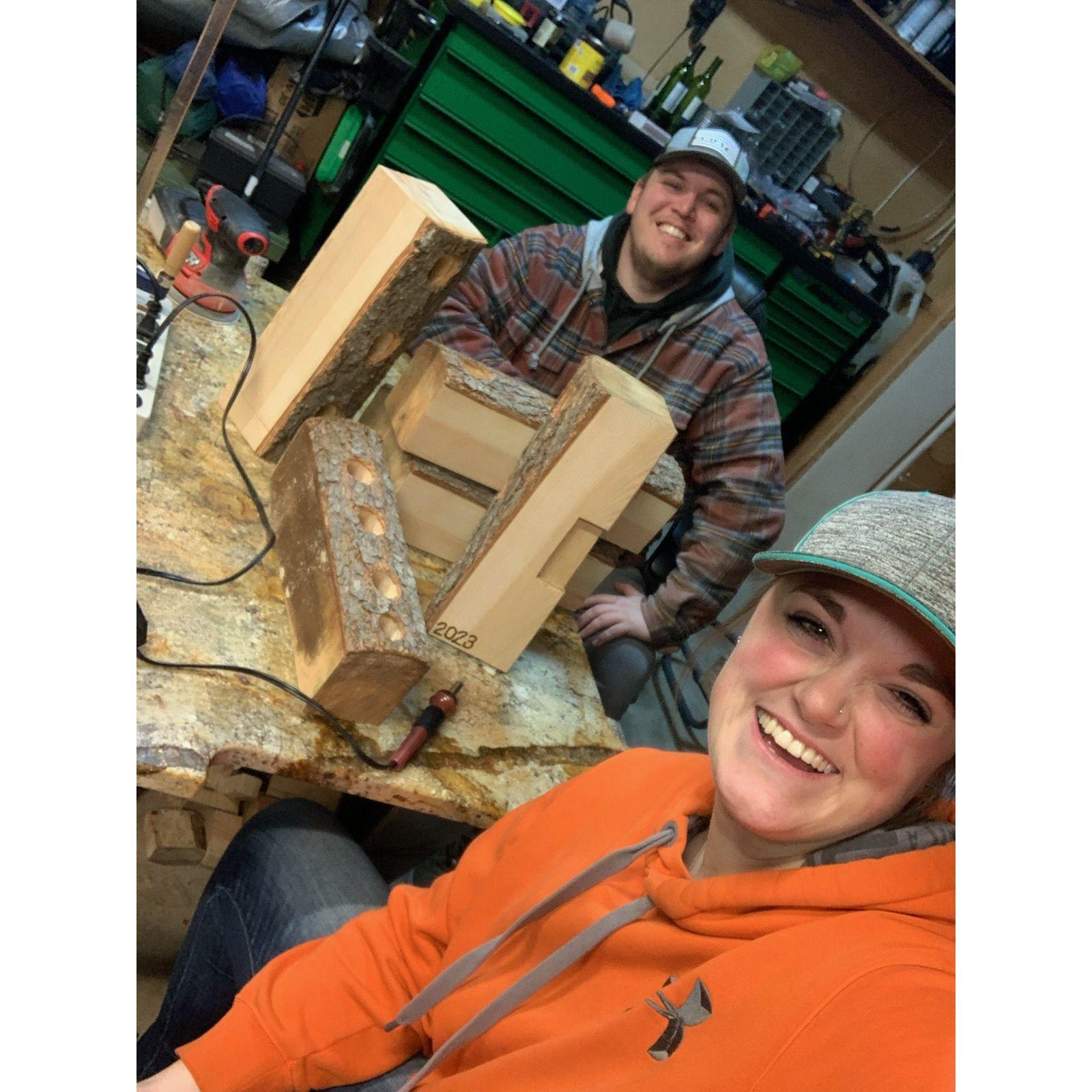 December 5, 2023 - Jack's family decided we were all going to make each other handmade gifts for this year's Christmas. So, Jack and I spent hours in his garage making wood, tree wine holders for everyone. We cut down a tree on his parent's property, cut pieces out, drilled the holes, sanded and stained them, and then we sat in his living room every night for a couple weeks and watched the whole series of Friends (our favorite tv show) while we wood burned different designs in each one. They turned out perfect, everyone loved them, and we had so much fun making them together!