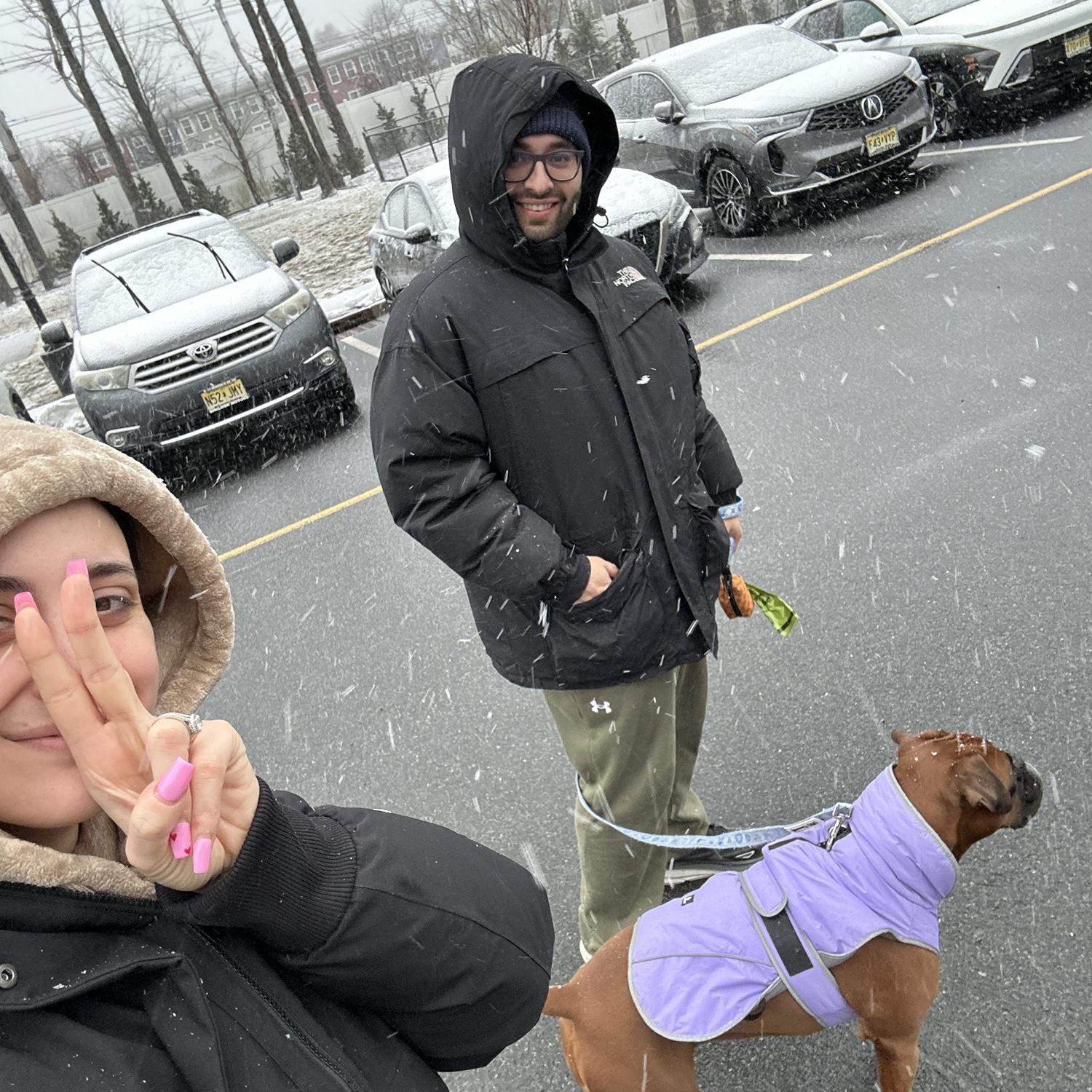 Us and our child braving the blizzard of 2026 so she can get her walk in