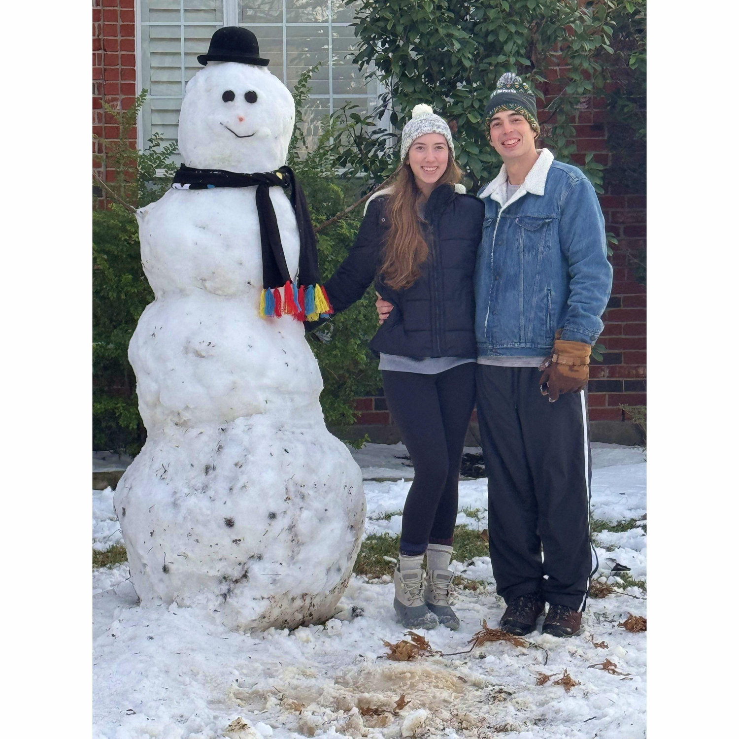 Us with our snowman in January 2025. This day we got snowed in together and it was so much fun!