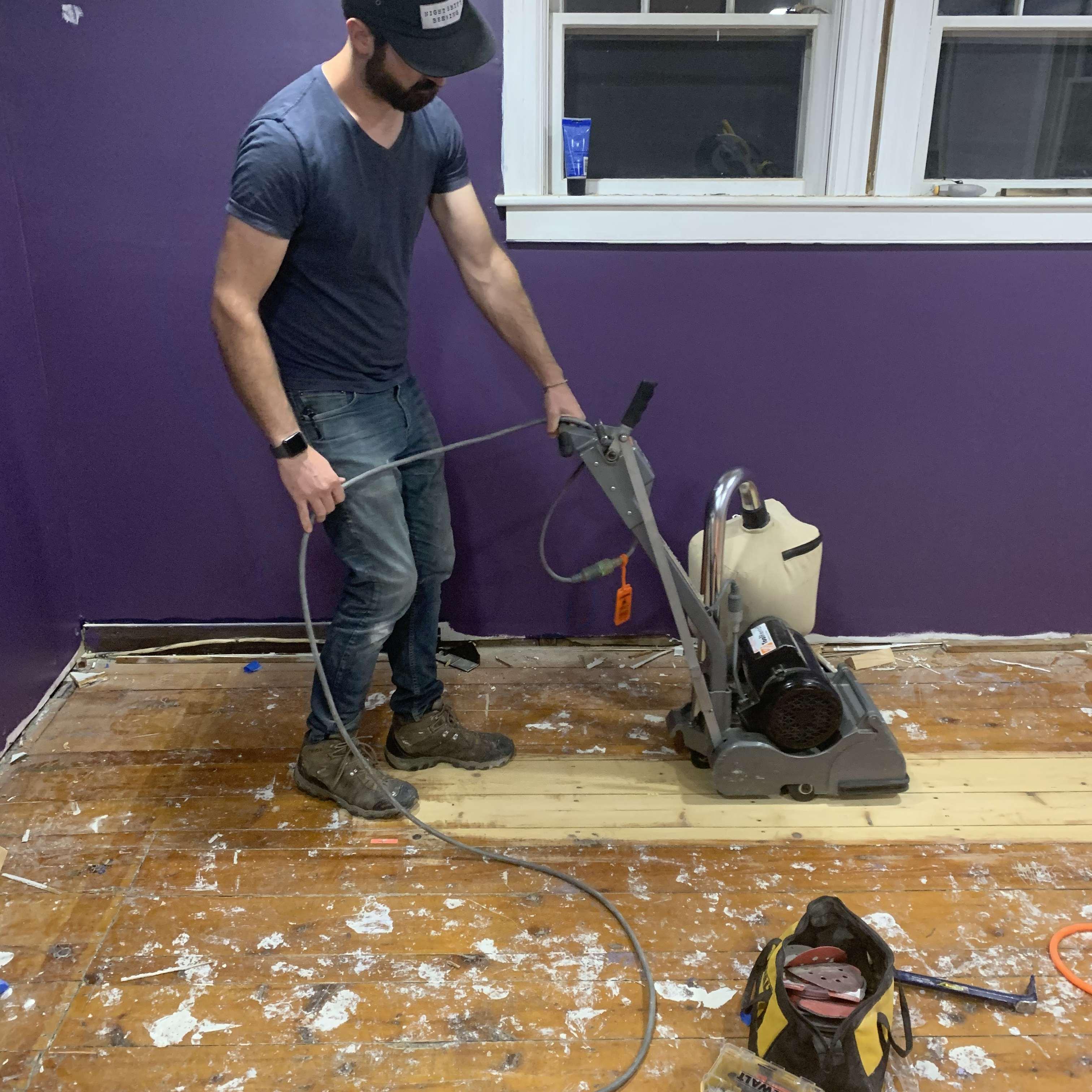 Sanding the bedroom floor only a month after we moved in!