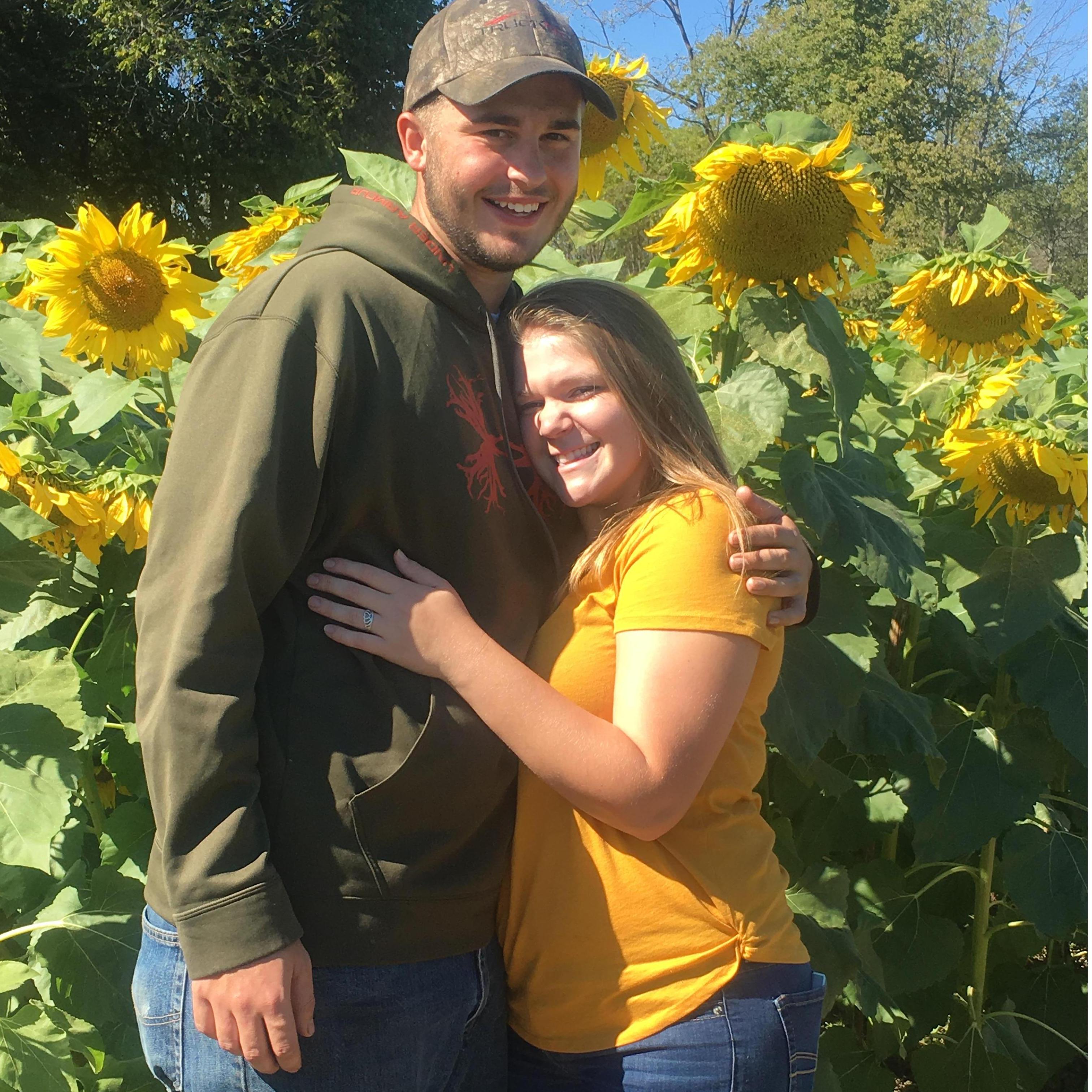 My best friend willingly taking a picture with me while in a sunflower field!