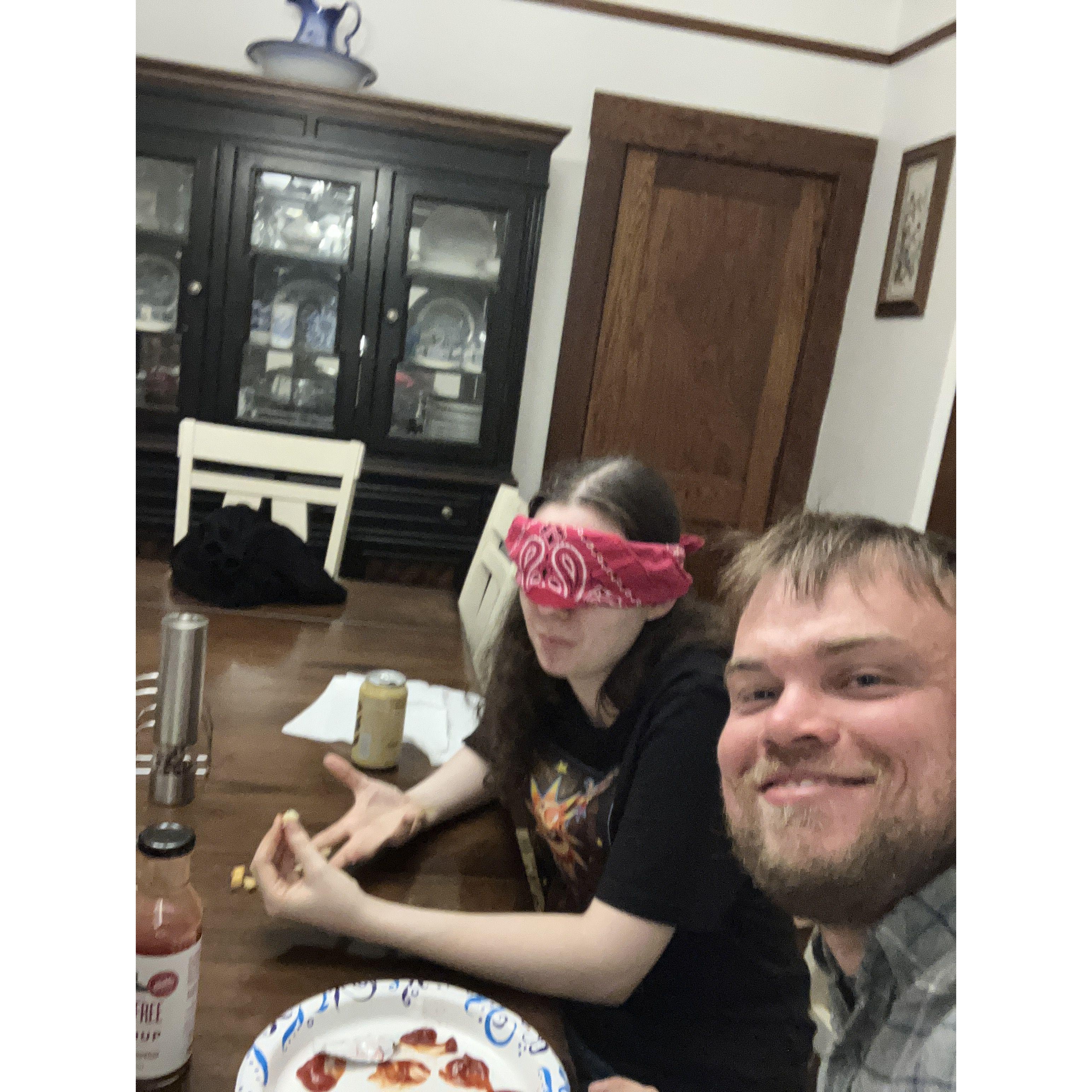 One blinded folded girlfriend taste testing the different ketchup brands her boyfriend bought, and one boyfriend snapping evidence of our shenanigans.