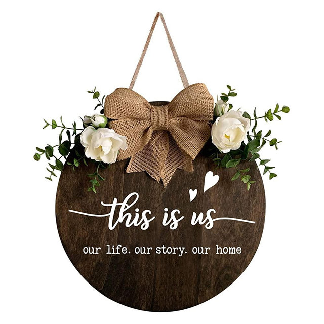 MayAvenue This is Us Wreaths Decor Sign Front Door, Round Wood Hanging Sign with Ribbon Bow and Artificial Green Leaves, Farmhouse Porch Decorations for Home Thanksgiving, Brown