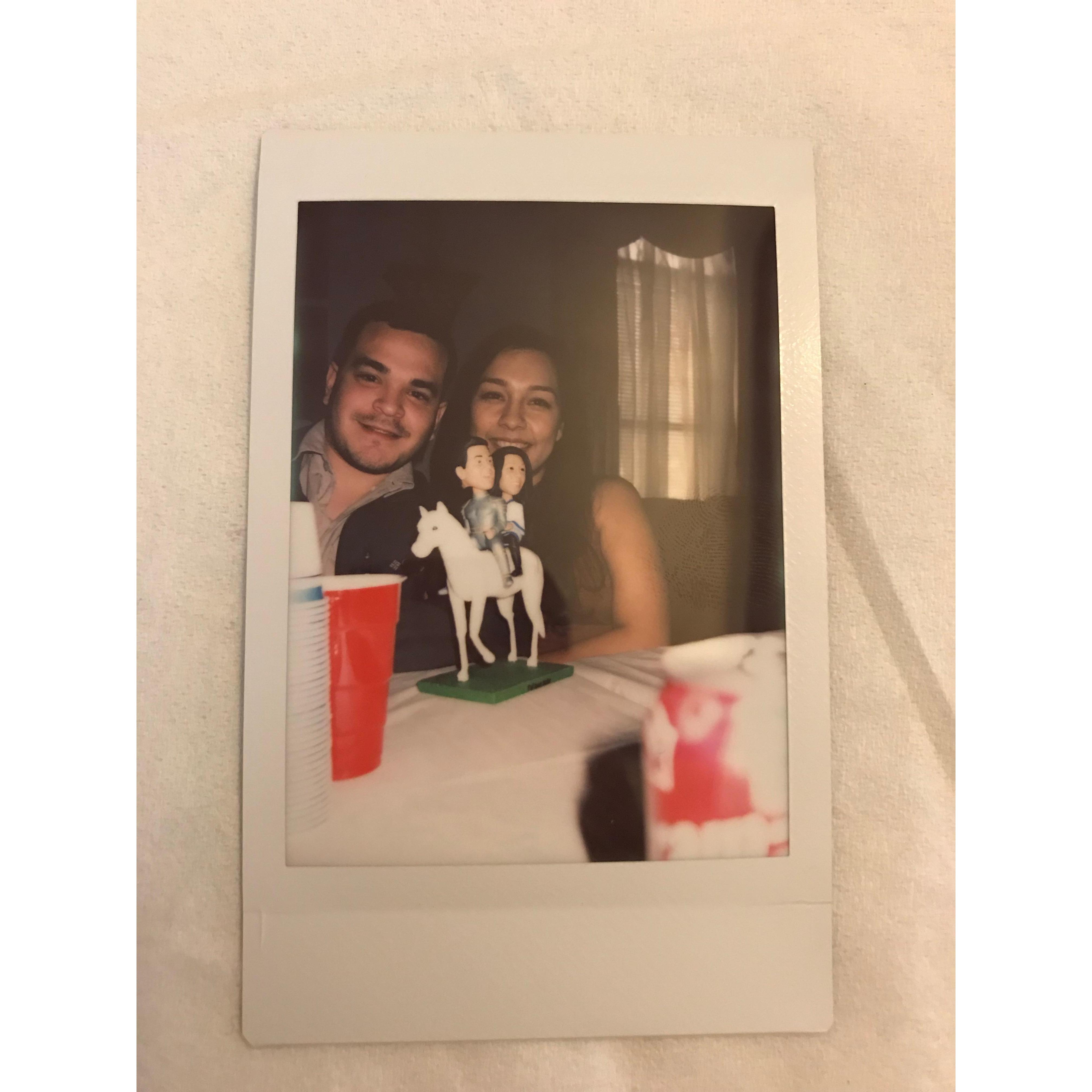 Candid Polaroid taken by a beloved niece on Christmas day, accompanied by our very own bobbleheads.