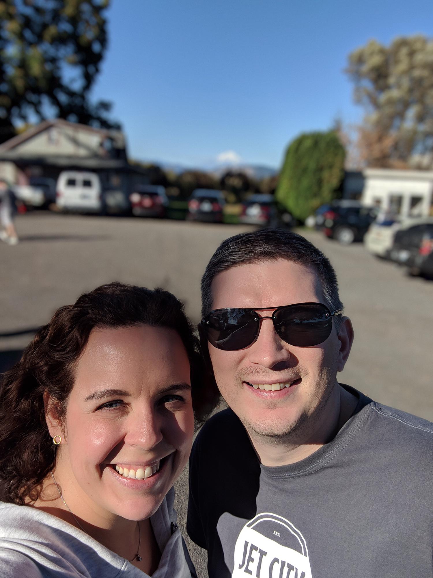 A selfie in a parking lot? Hmm.