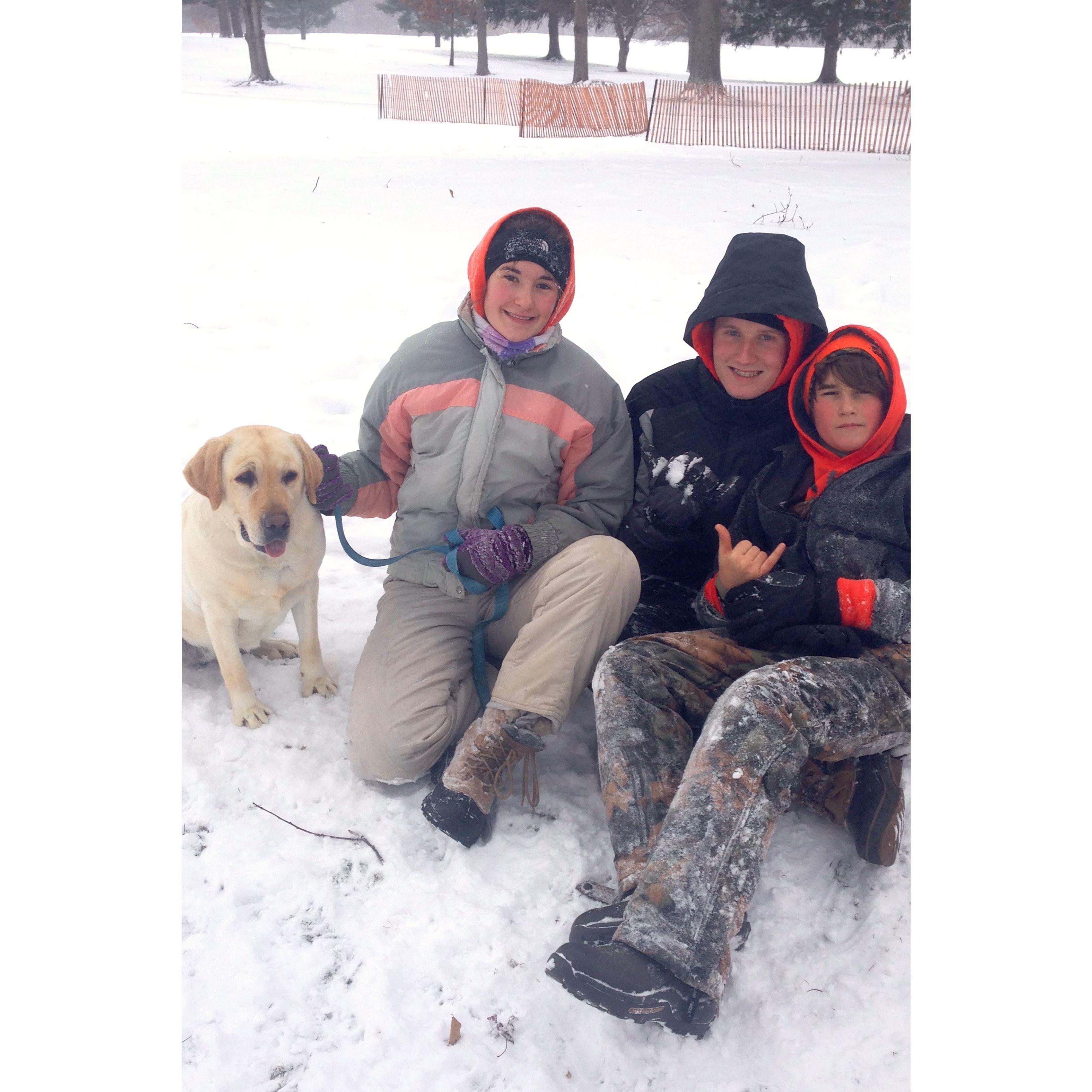 Sledding at the Ashland Country Club with Madison's younger brother and groomsman, Cade, and late dog, Sasha.