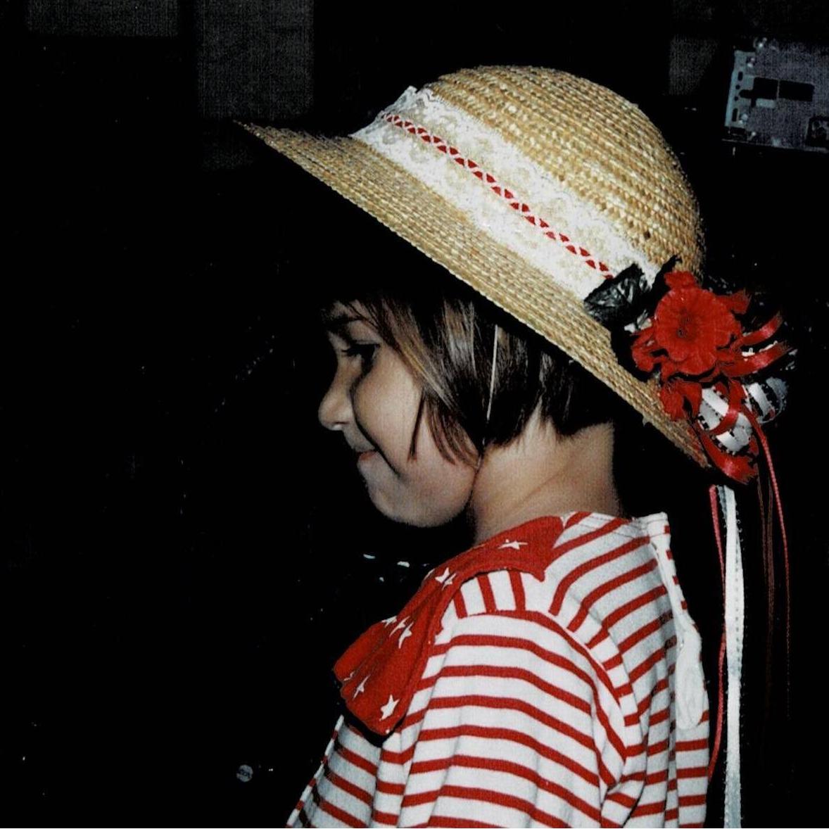 Young Marina wearing a hat beautifully made by her mother