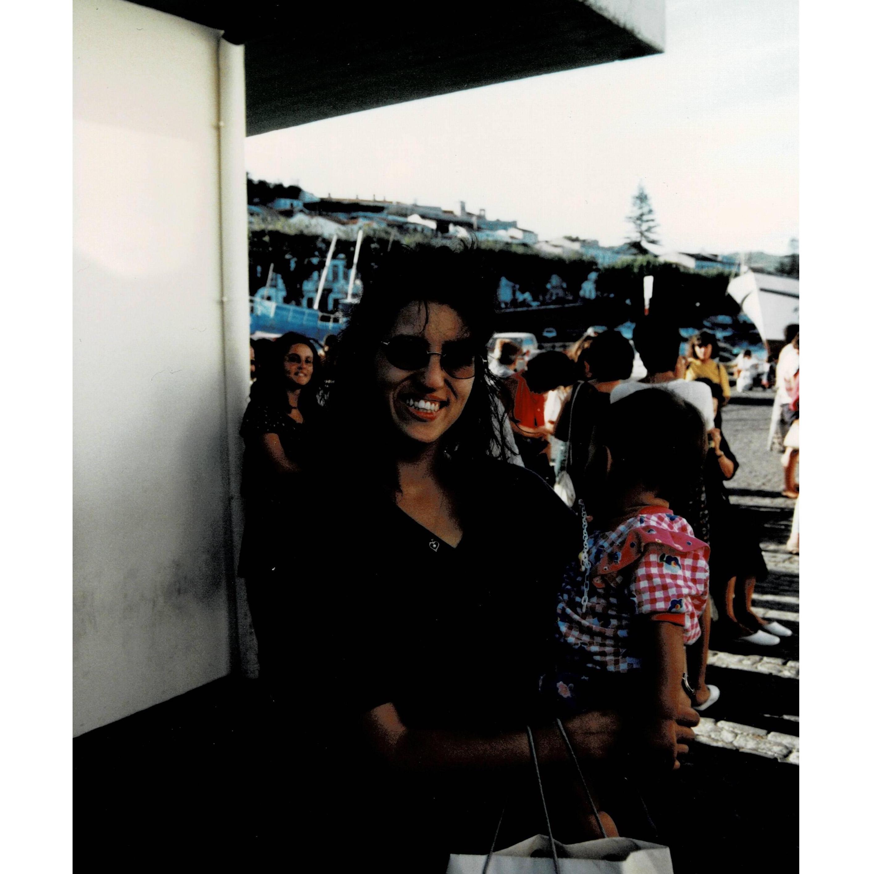 Marina and her mom waiting on a boat to take them to another island