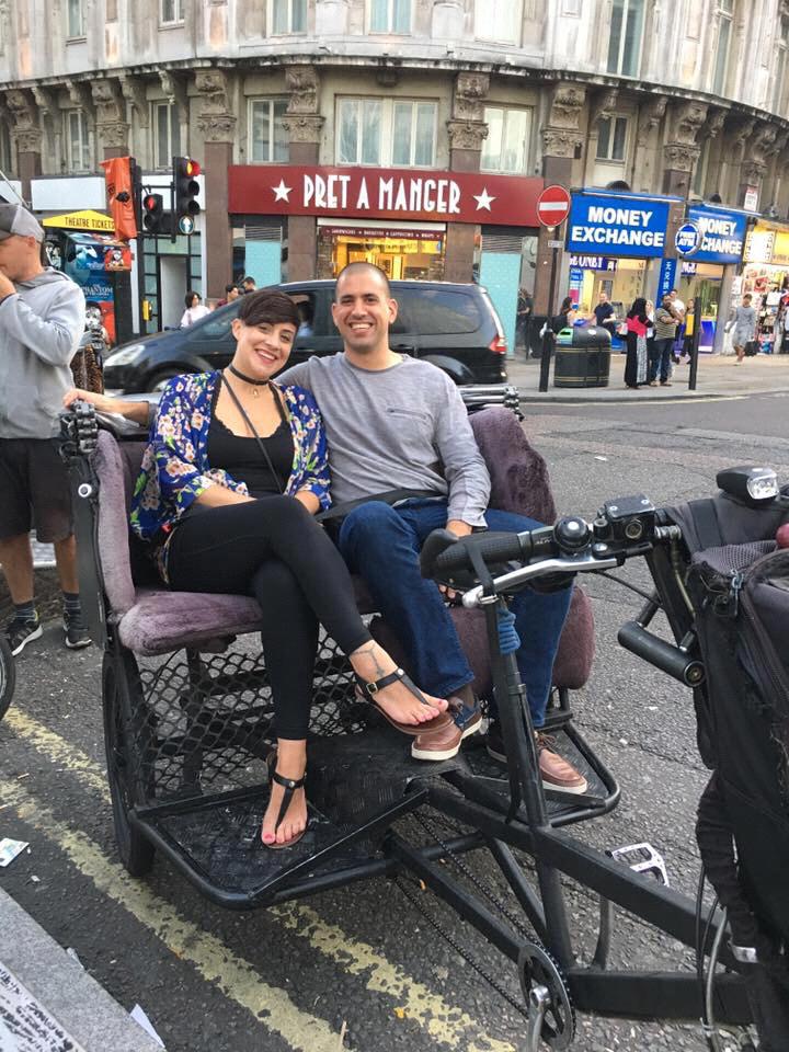 "The day after Curtis proposed" a very happy couple ride through London, England in a rickshaw.
