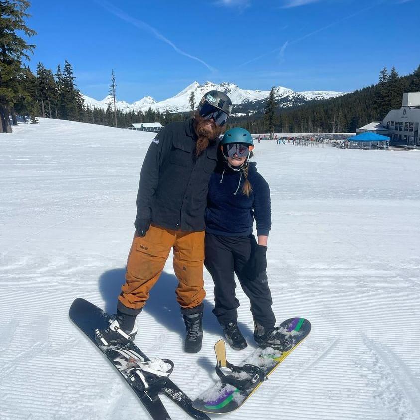 Laura made Josh try out a snowboard